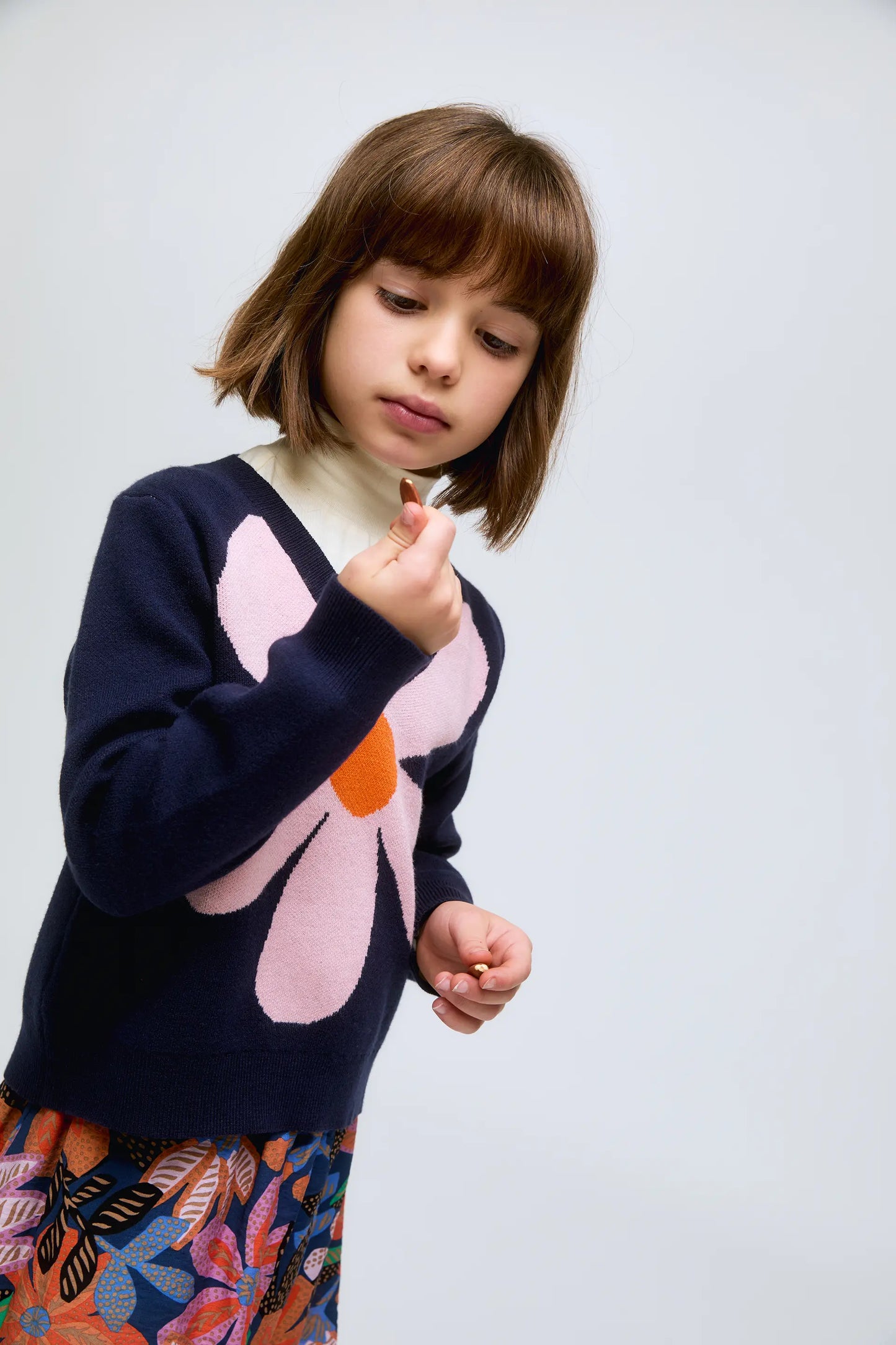 Navy blue knitted girl's sweater with flower print