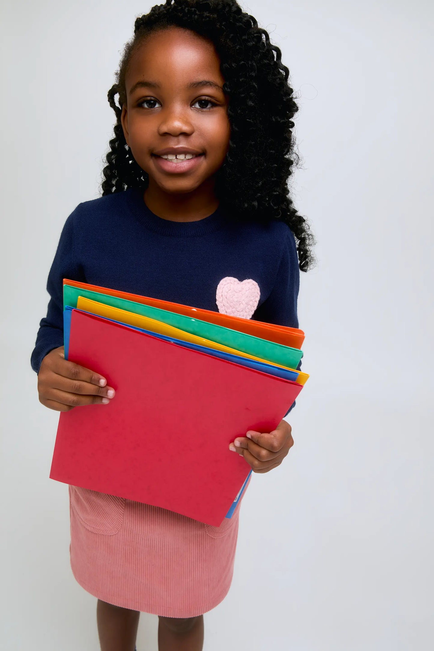 Navy blue knitted girl's sweater with pink heart embroidery
