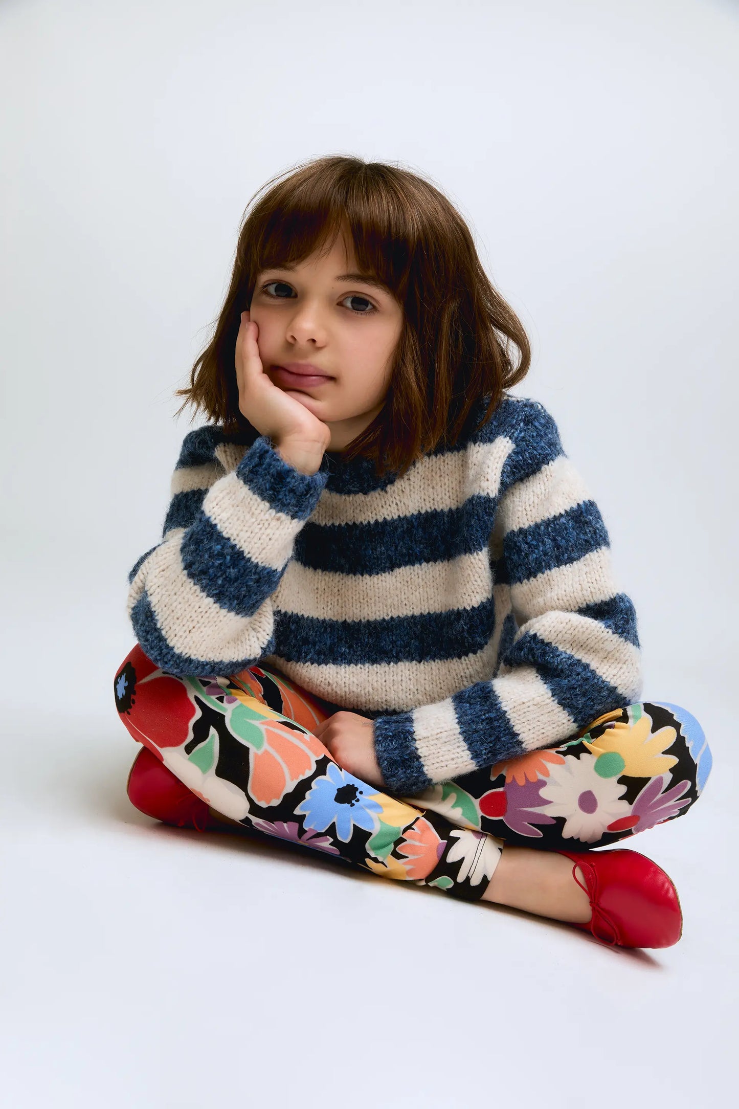 White and blue striped knitted girl's sweater