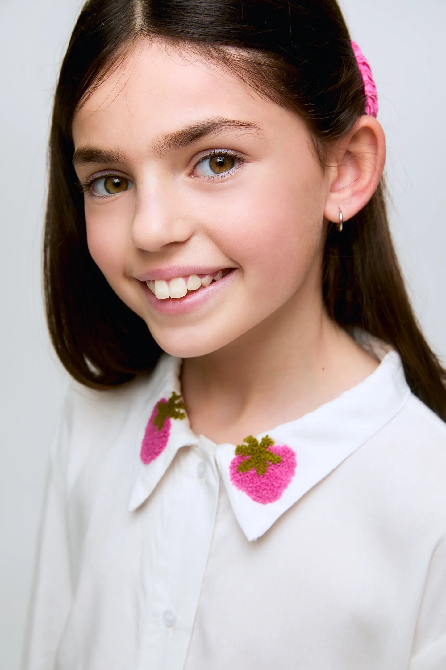Girl's white shirt with strawberry embroidered collar.