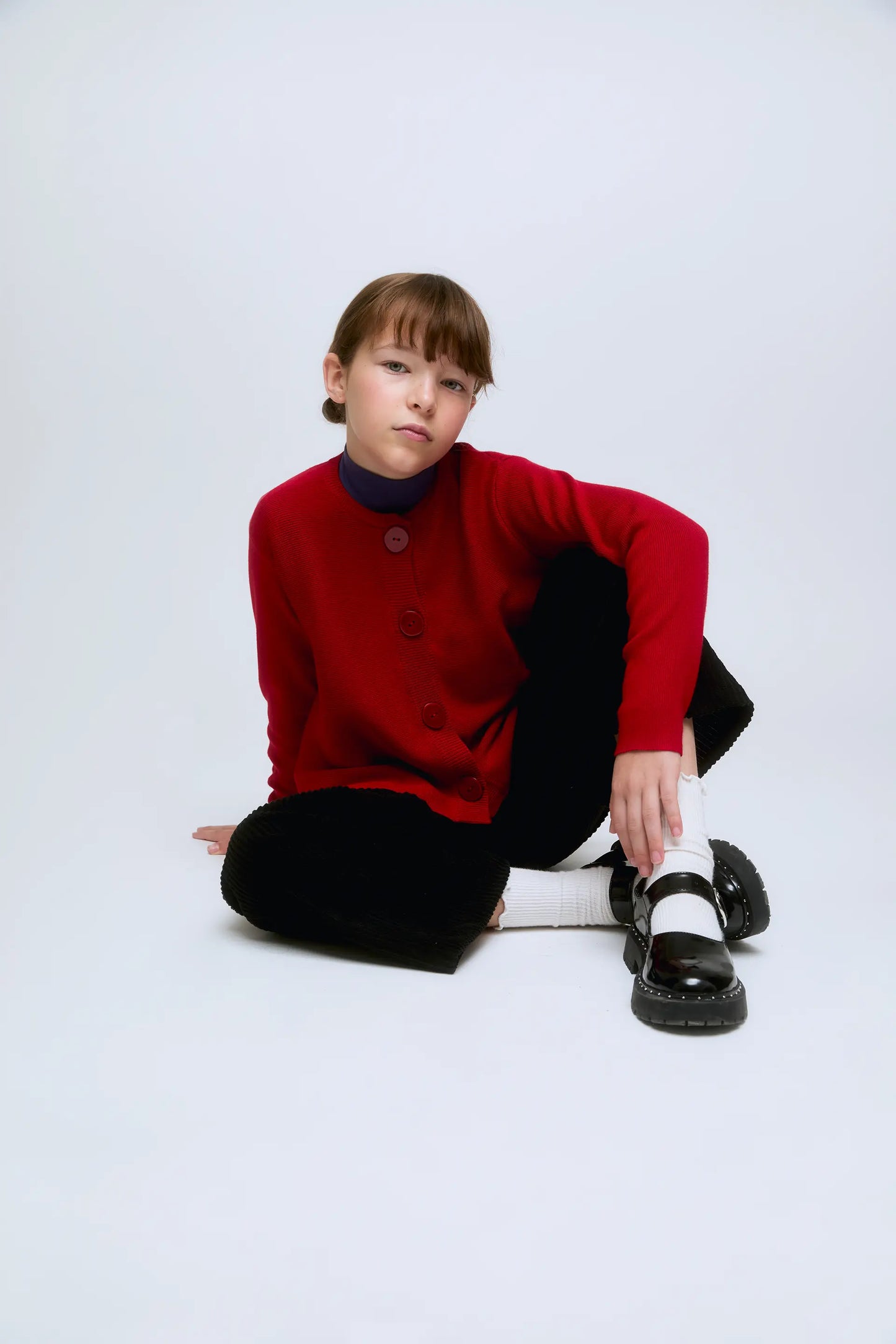 Cardigan rosso in maglia con bottoni bianchi e rossi sul davanti