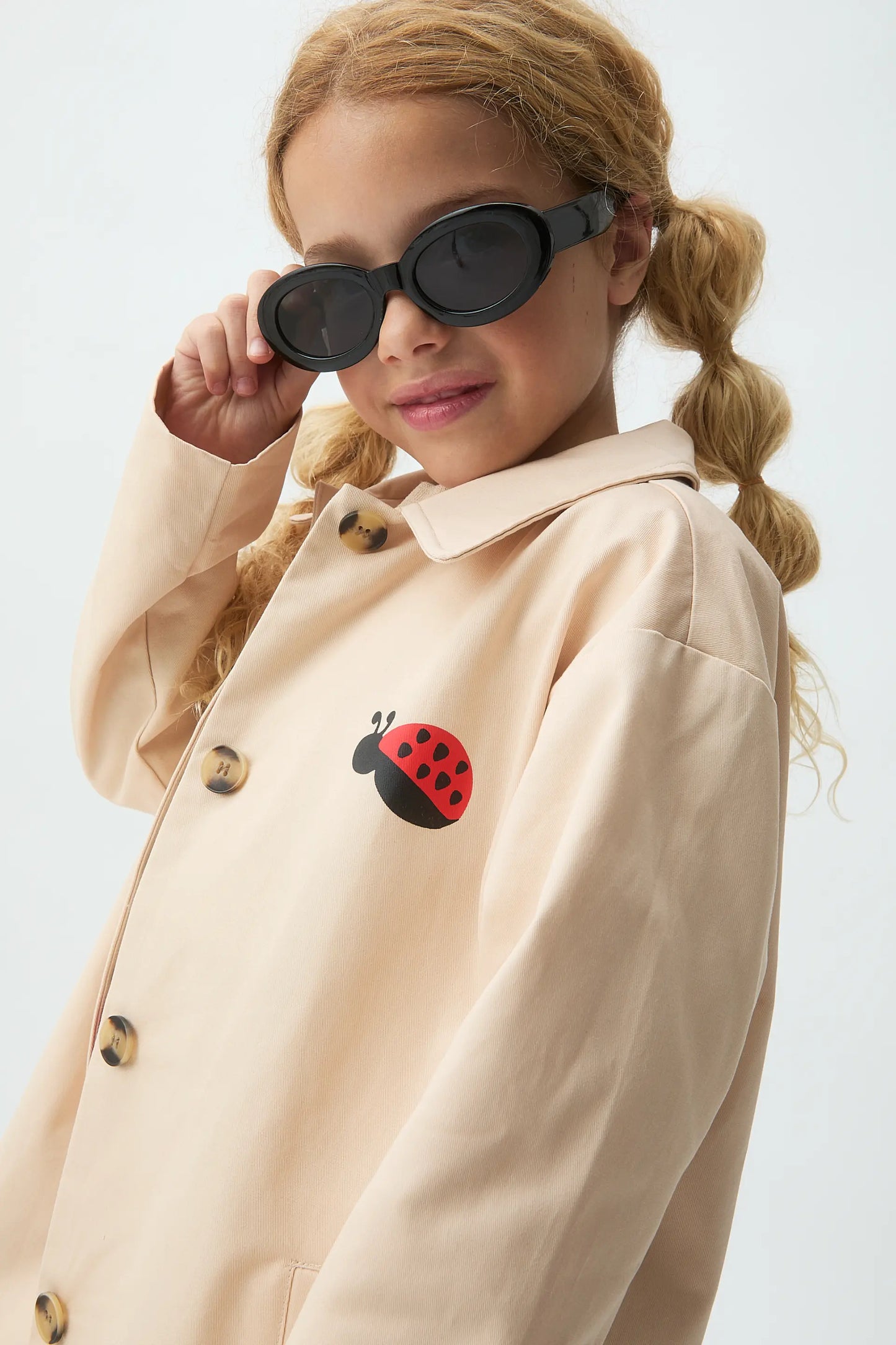 Girl's trench coat with ladybug print