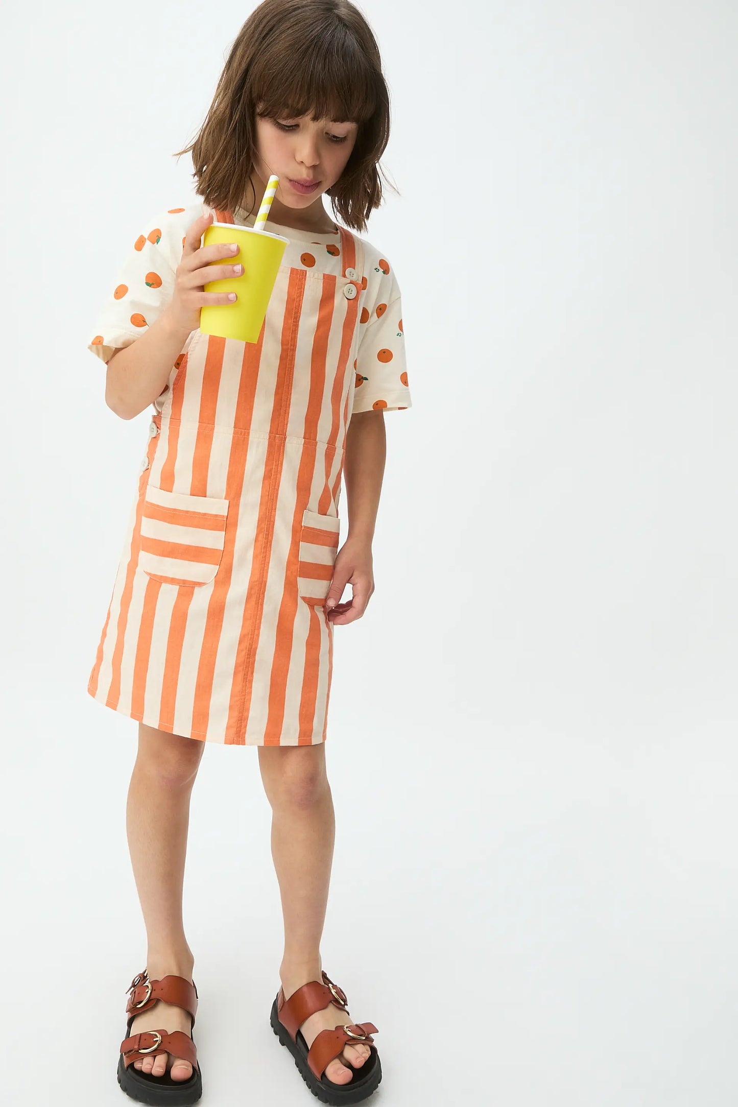 Girl's pinafore dress with orange bamboo print