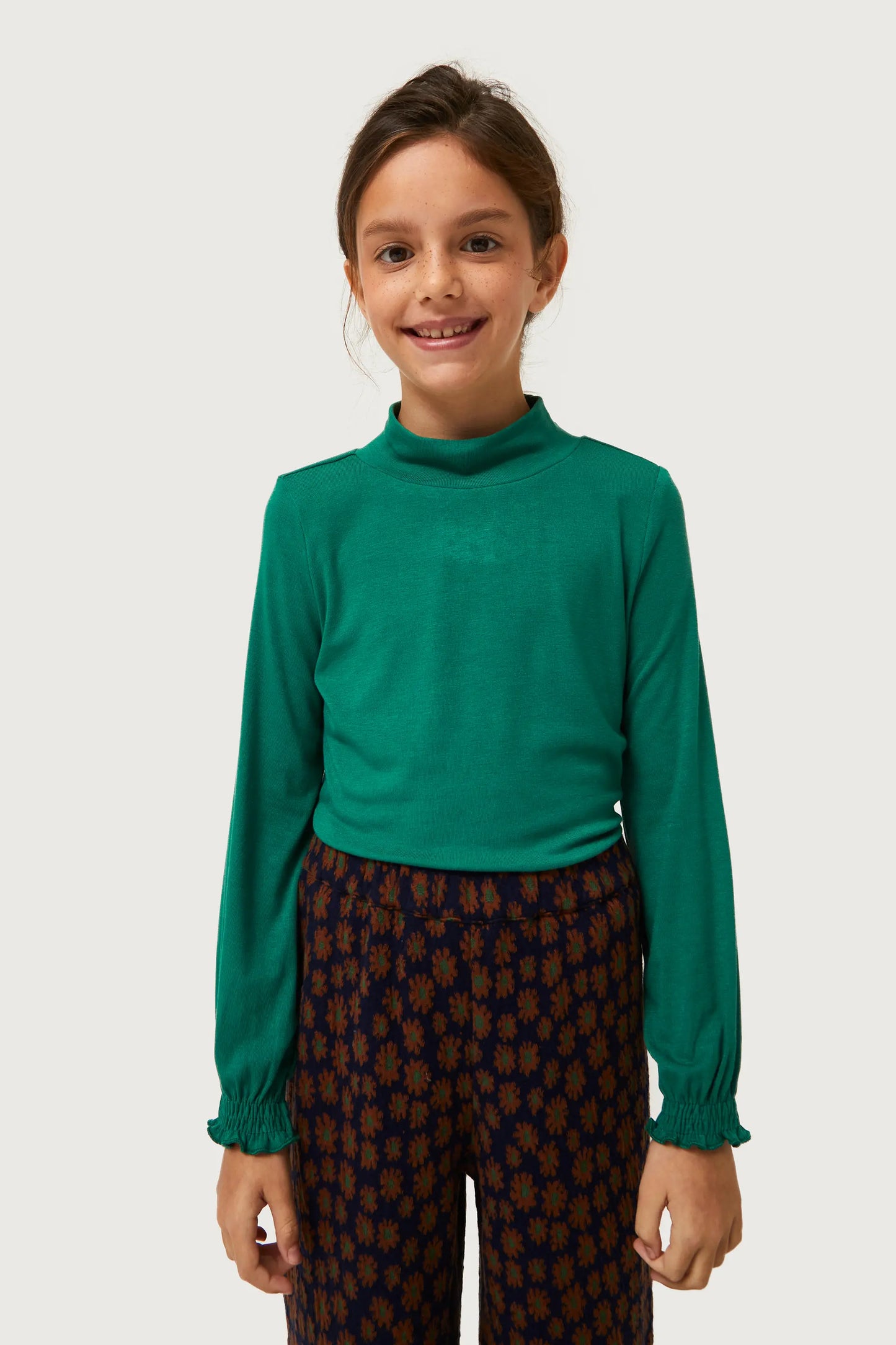 Girl's green turtleneck top