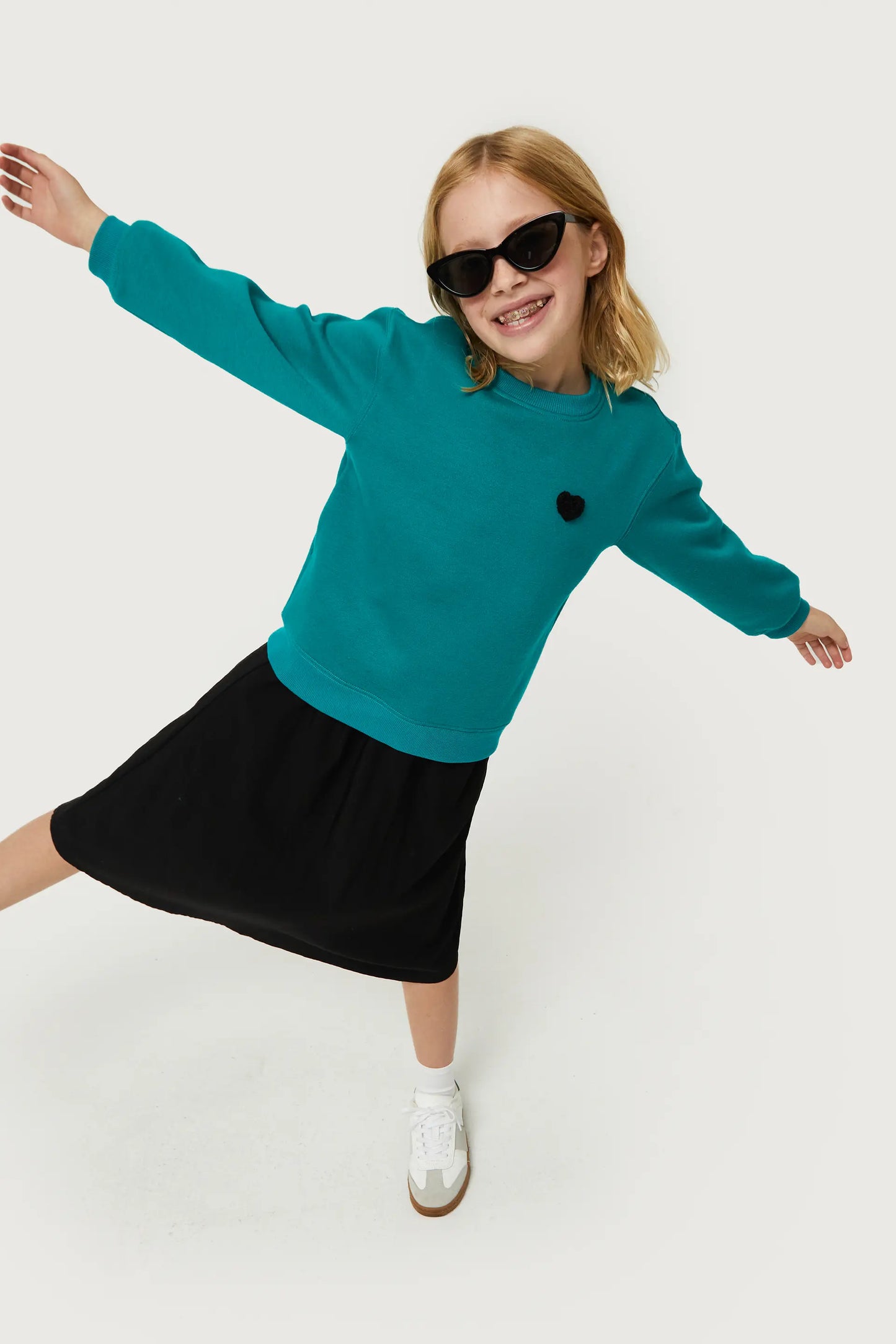 Girl's sweatshirt with green heart patch