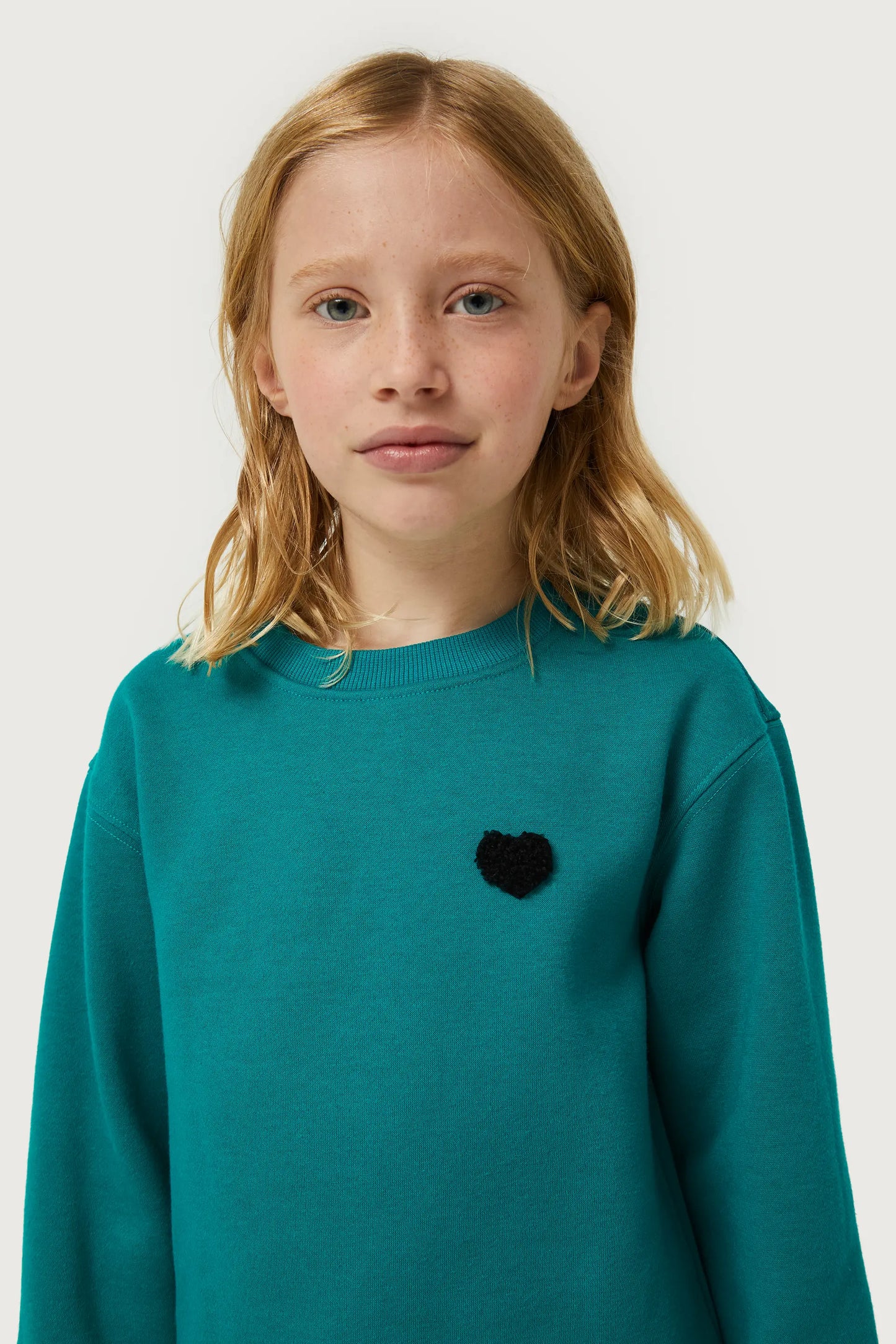 Girl's sweatshirt with green heart patch