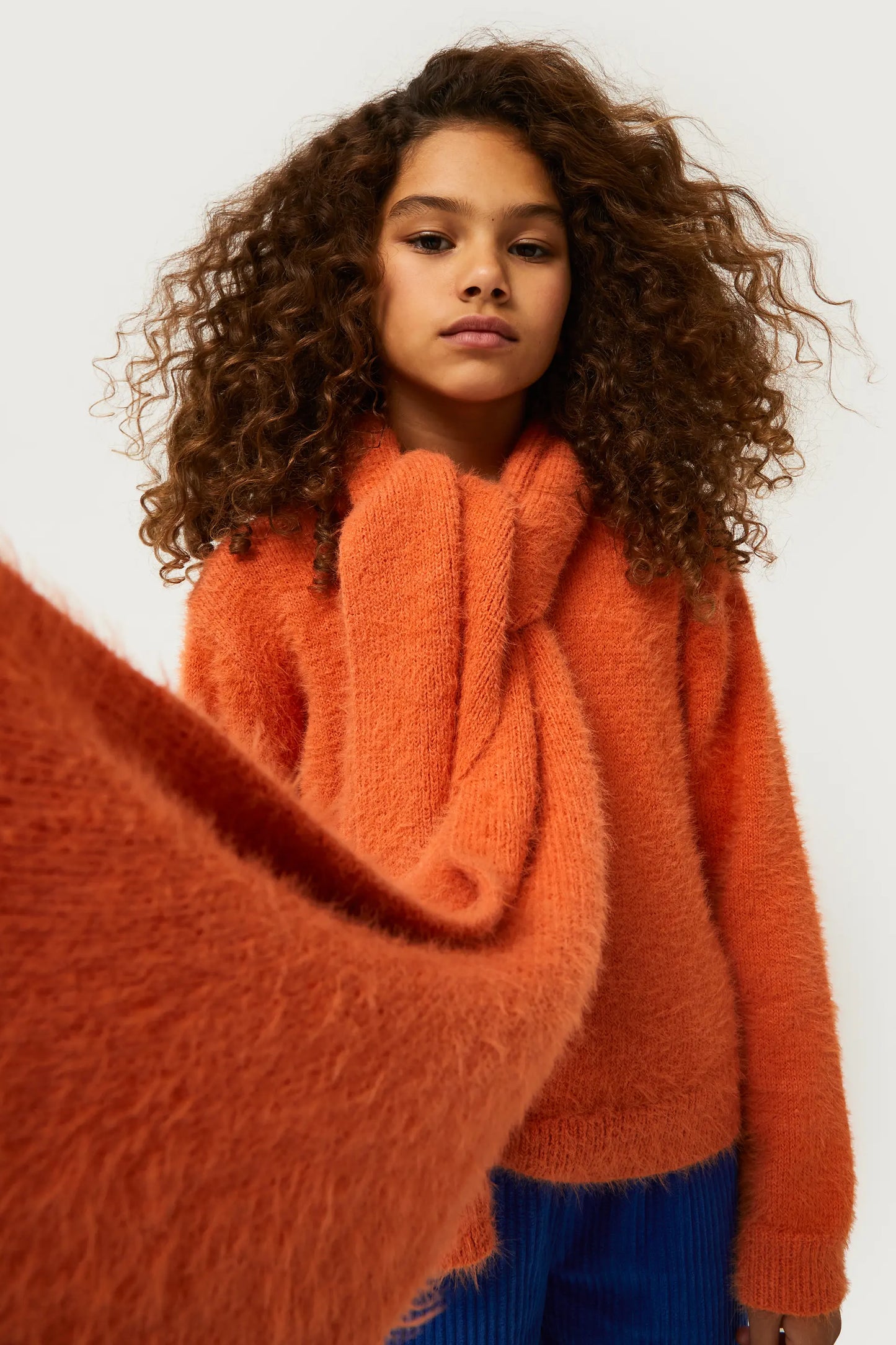 Girl's knitted sweater with orange texture