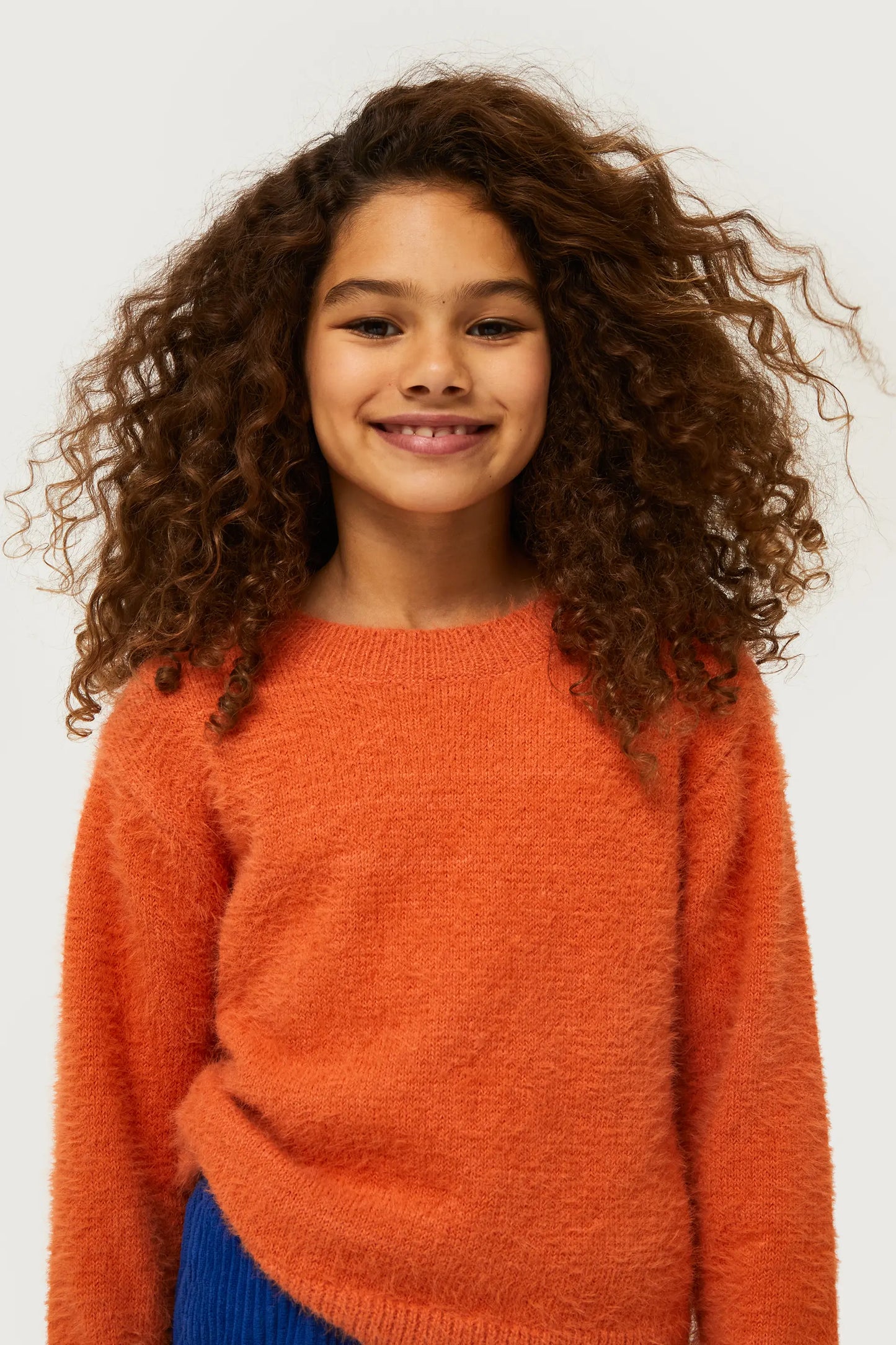 Girl's knitted sweater with orange texture