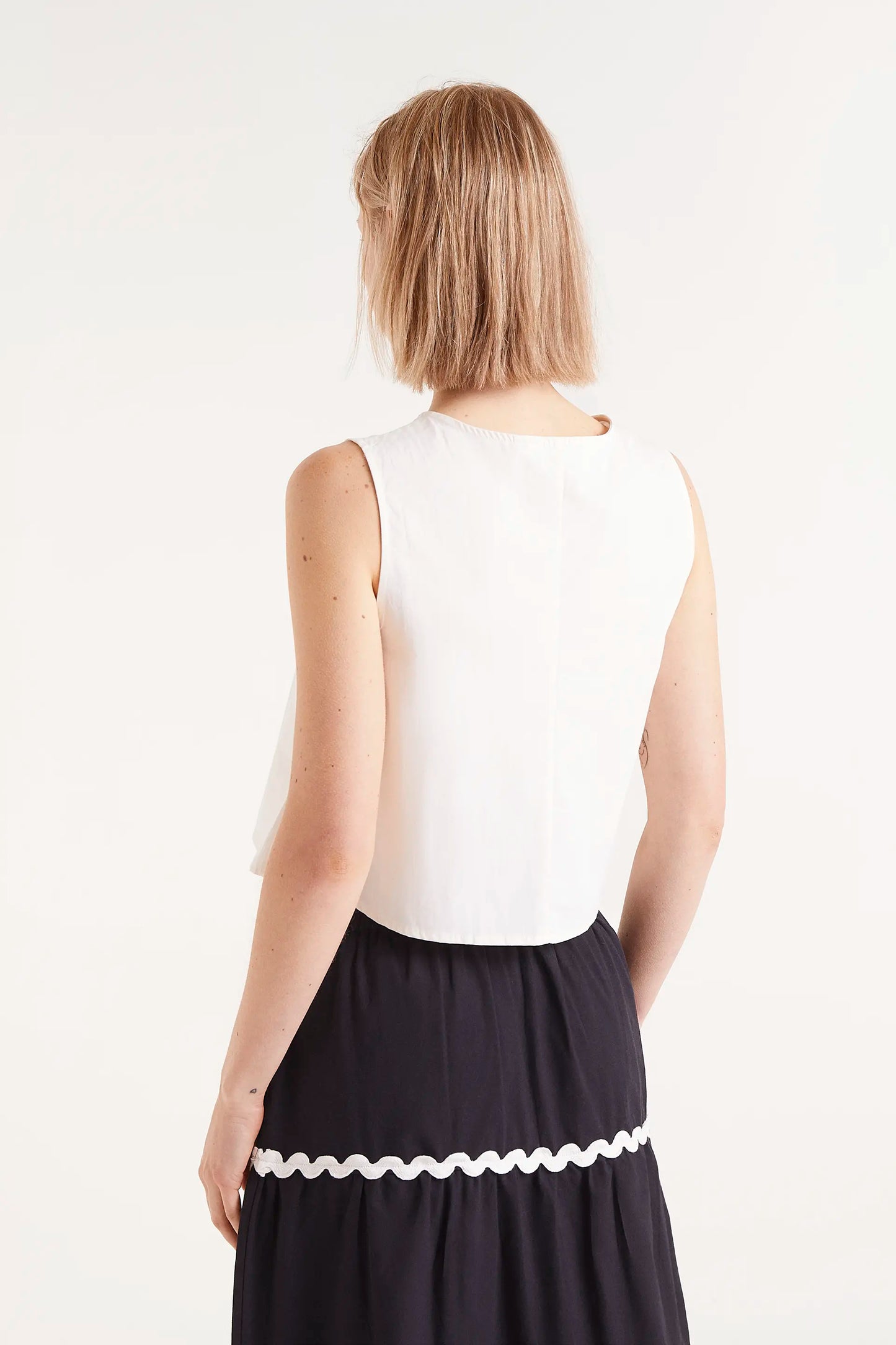 White buttoned sleeveless top