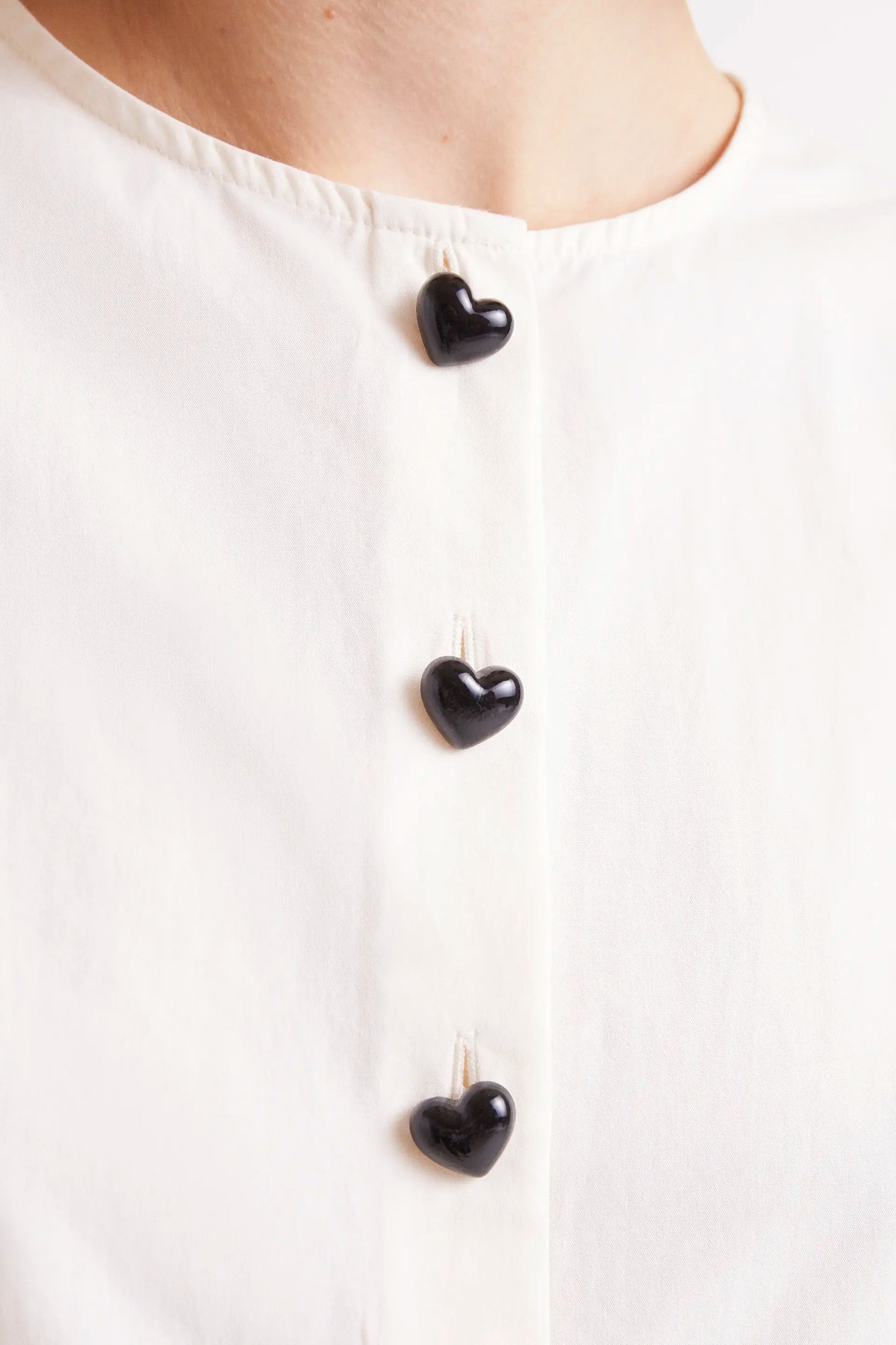 White buttoned sleeveless top