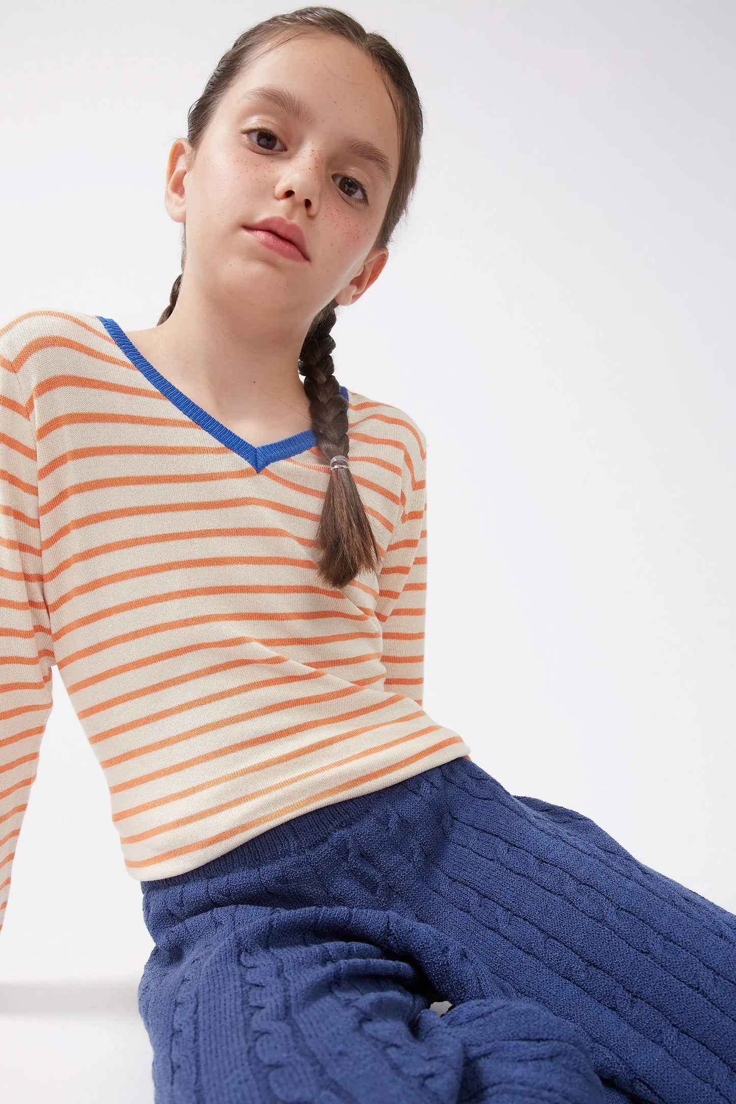 Girl's orange striped V-neck sweater