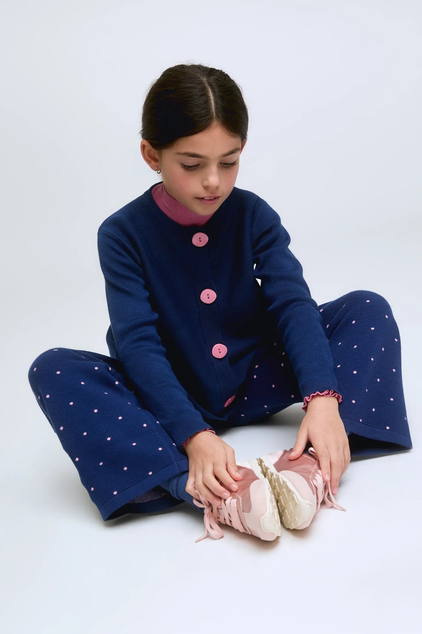 Navy blue fine knit girl's cardigan with contrasting buttons