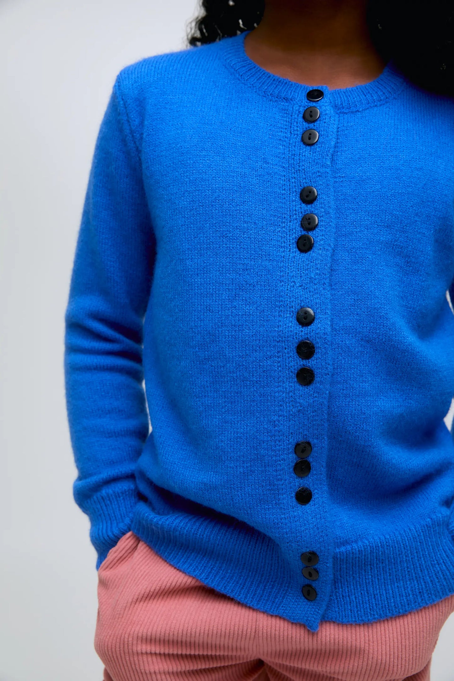 Blue knit girl's cardigan with triple breasted