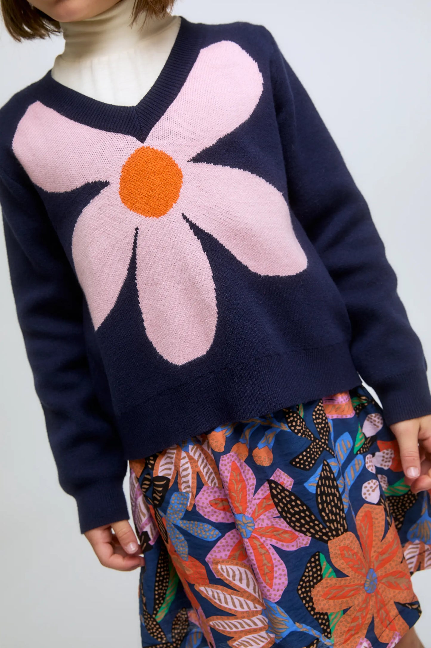 Navy blue knitted girl's sweater with flower print