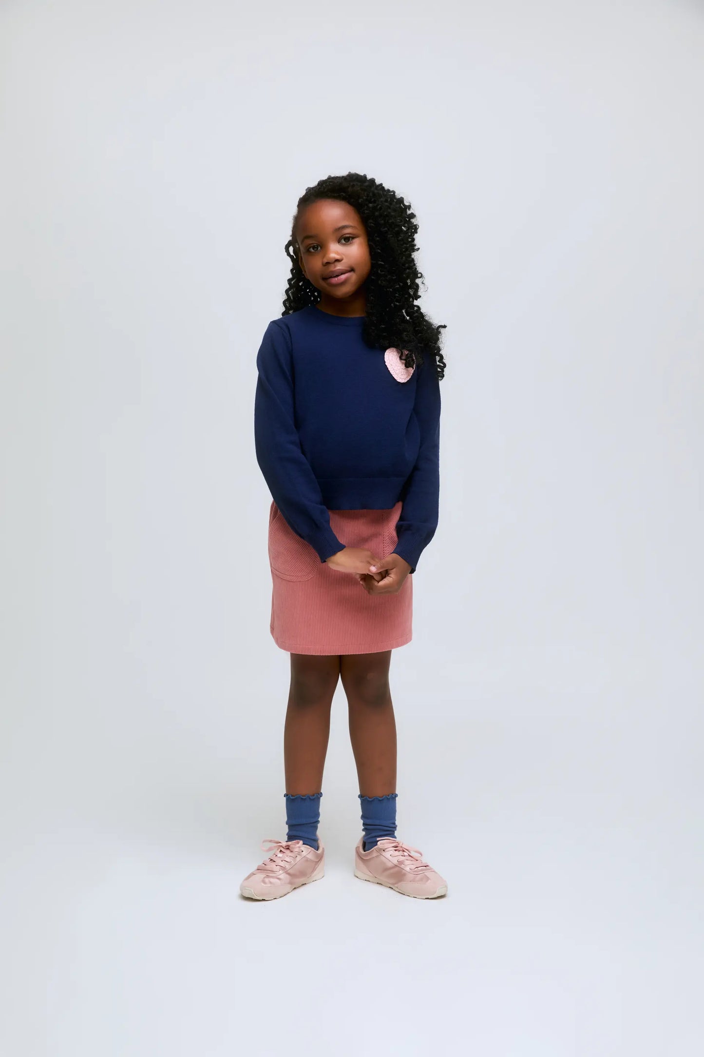 Navy blue knitted girl's sweater with pink heart embroidery
