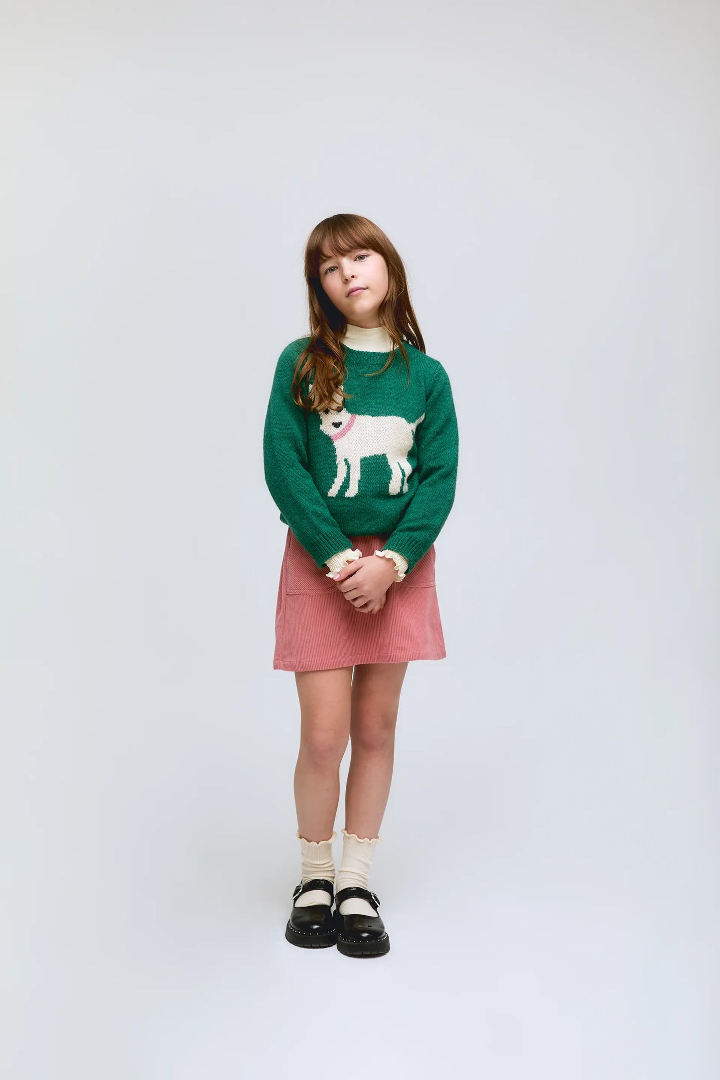 Green knitted girl's sweater with dog print
