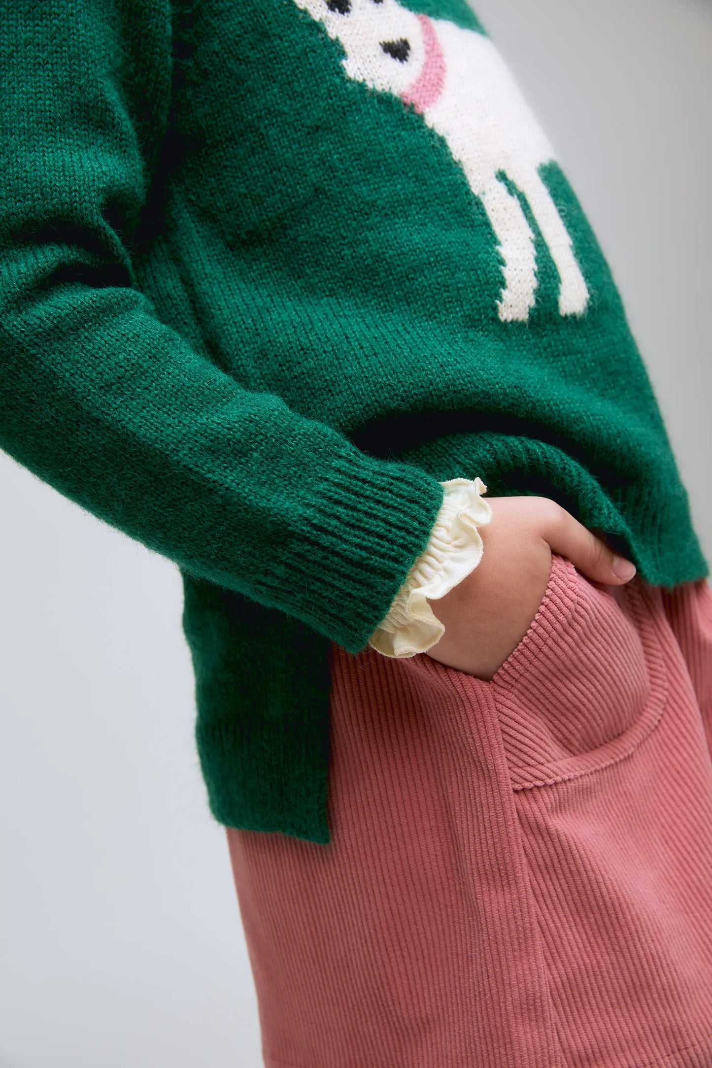 Green knitted girl's sweater with dog print