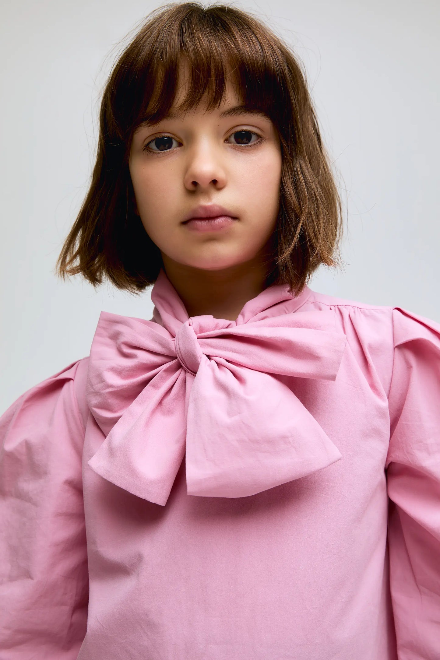 Pink cotton shirt with bow at the neck