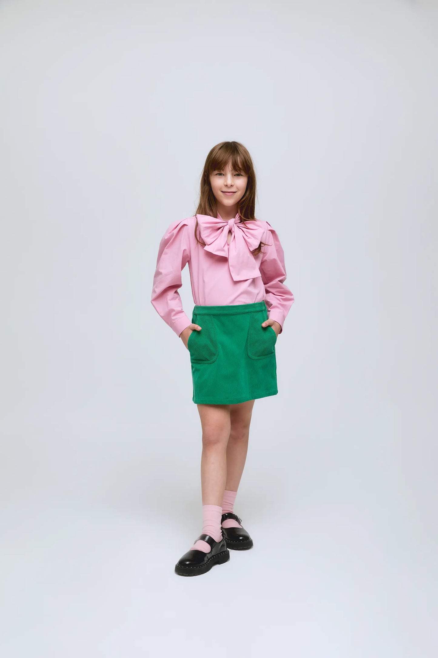 Short green corduroy skirt with front pockets