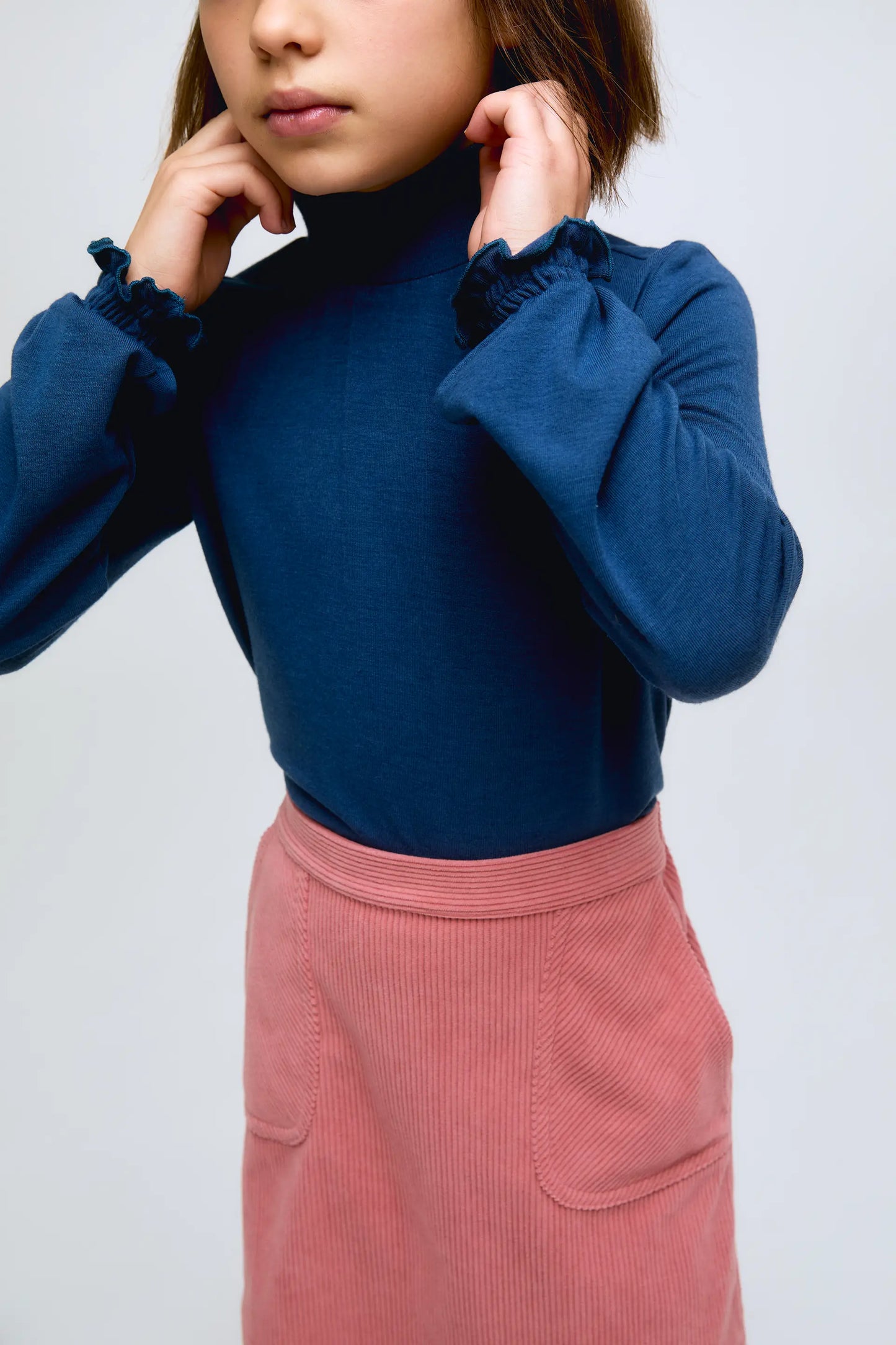 Blue girl's turtleneck sweater with gathered cuffs