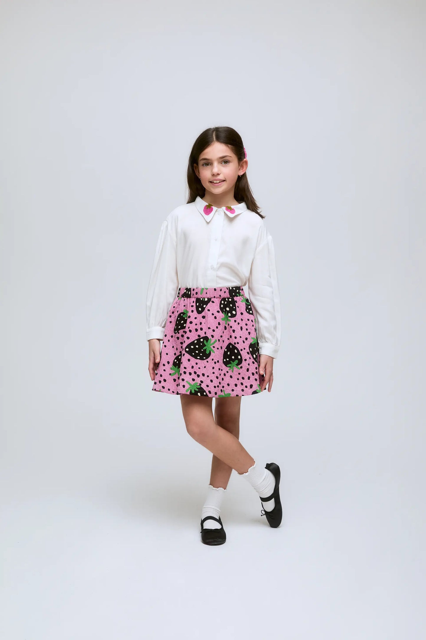 Girl's white shirt with strawberry embroidered collar.
