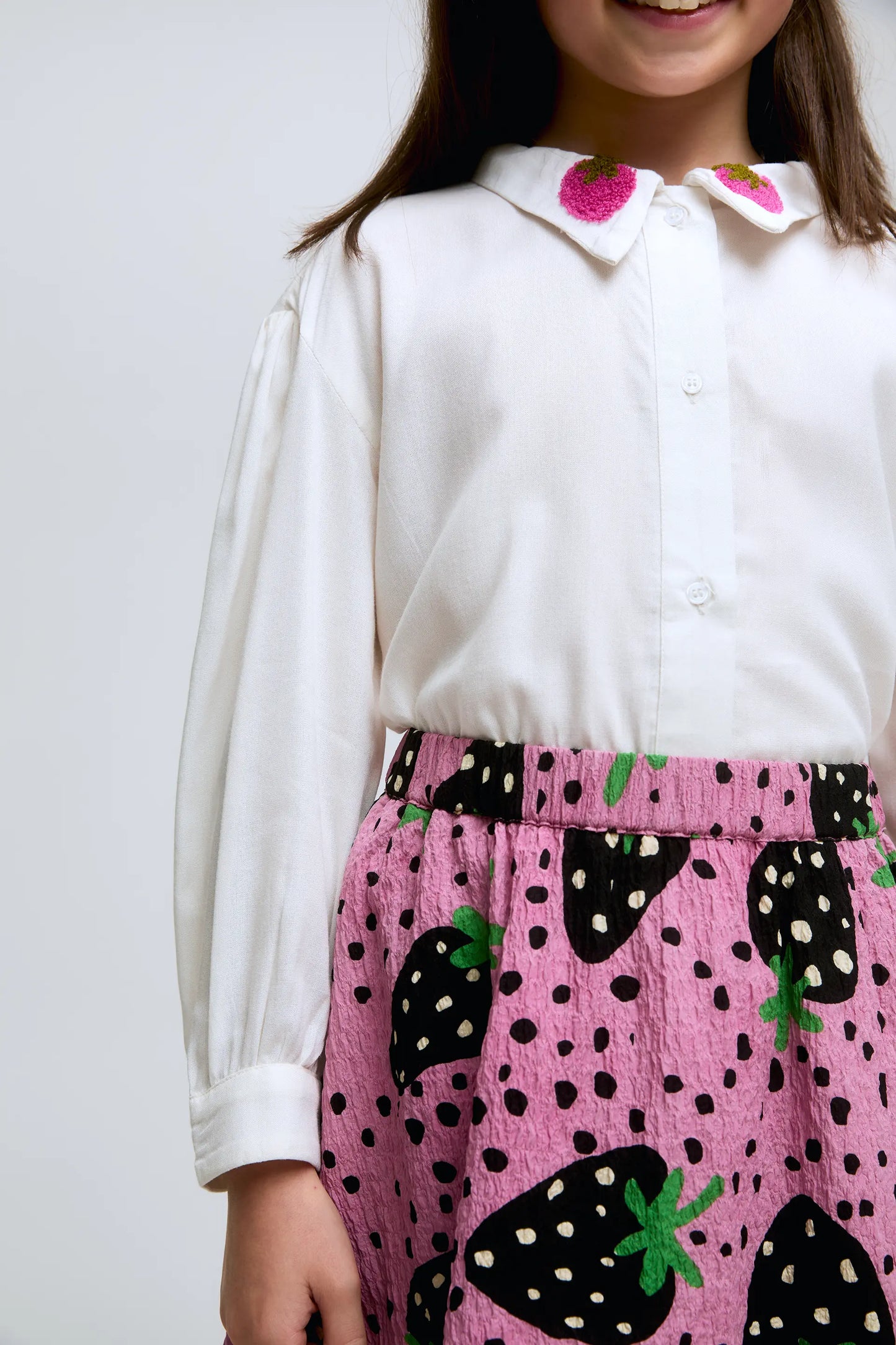 Girl's white shirt with strawberry embroidered collar.