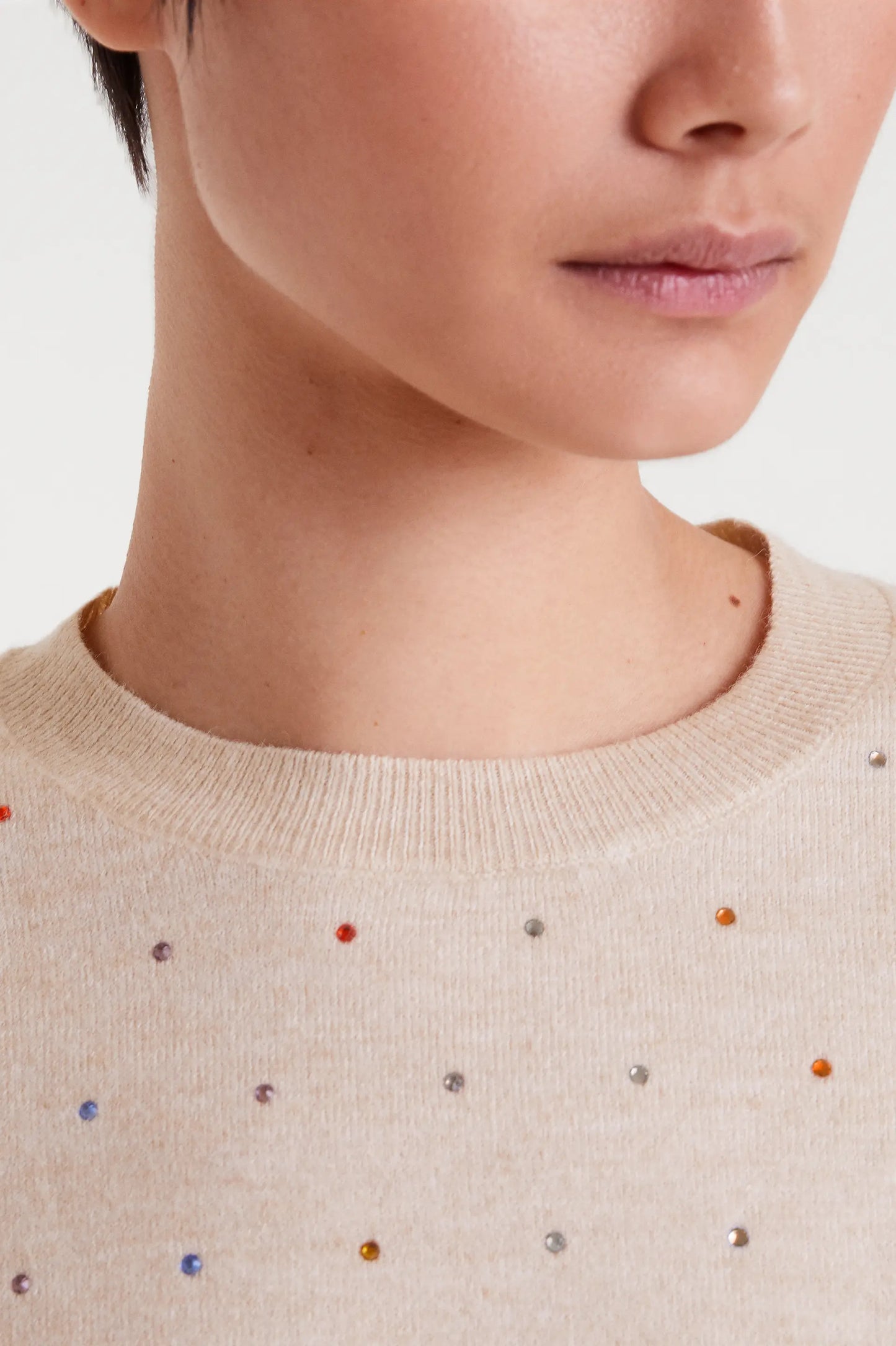 Beige fine knit sweater with multi-colored details