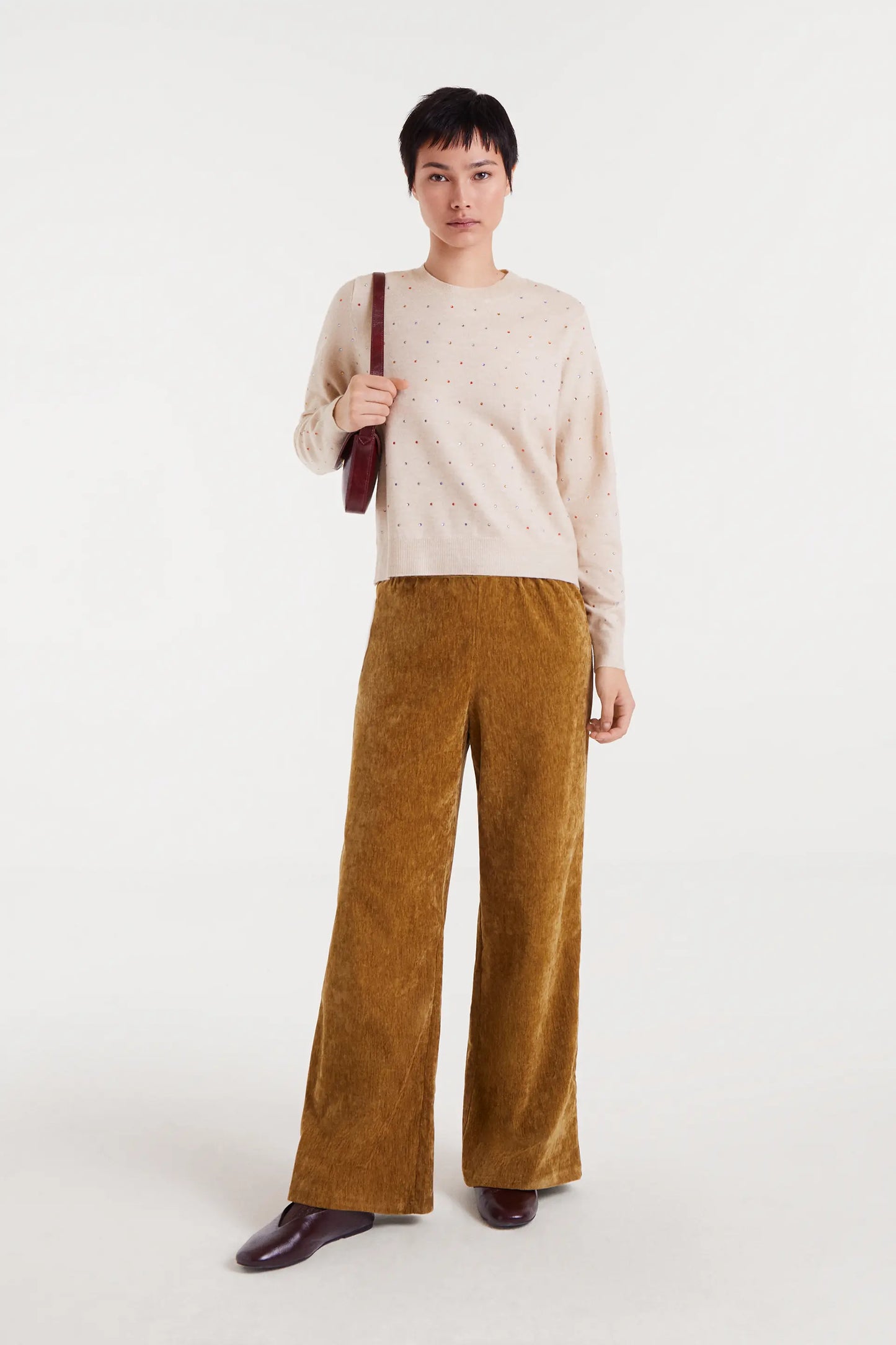 Beige fine knit sweater with multi-colored details