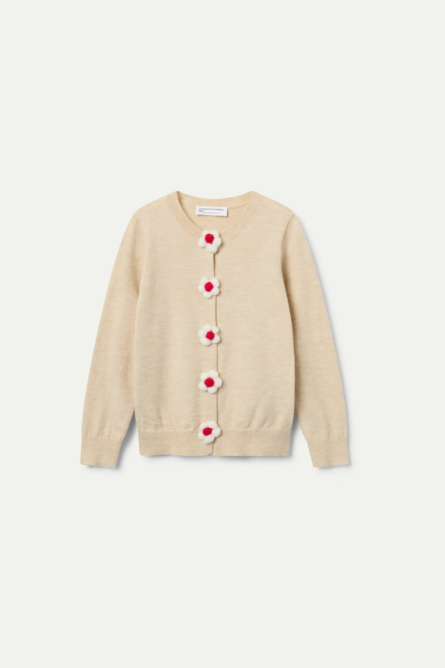 Cardigan beige de punto con botones en forma de flor.