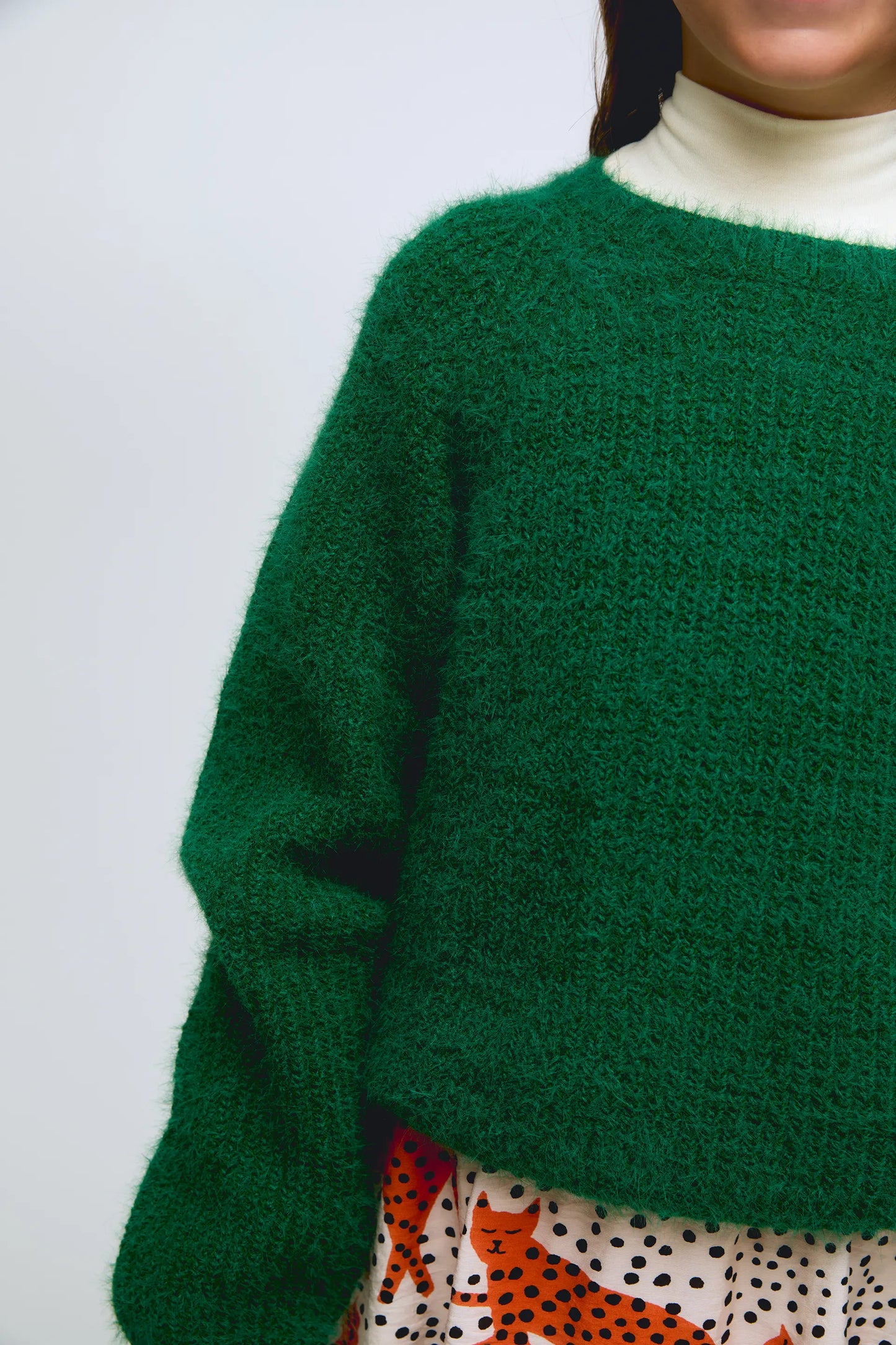 Green knitted girl's sweater.