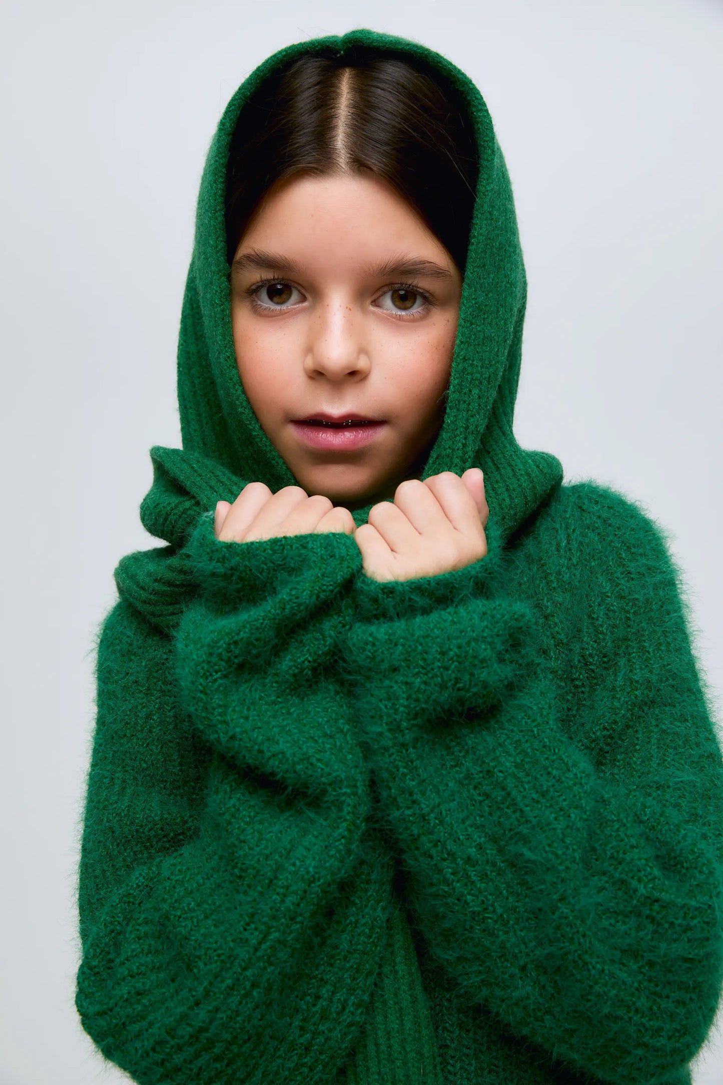 Green knitted girl's sweater.