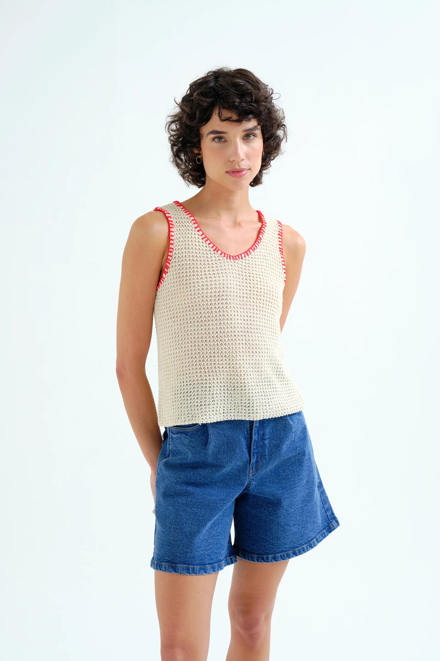 Off-white openwork knit top with red embroidered details