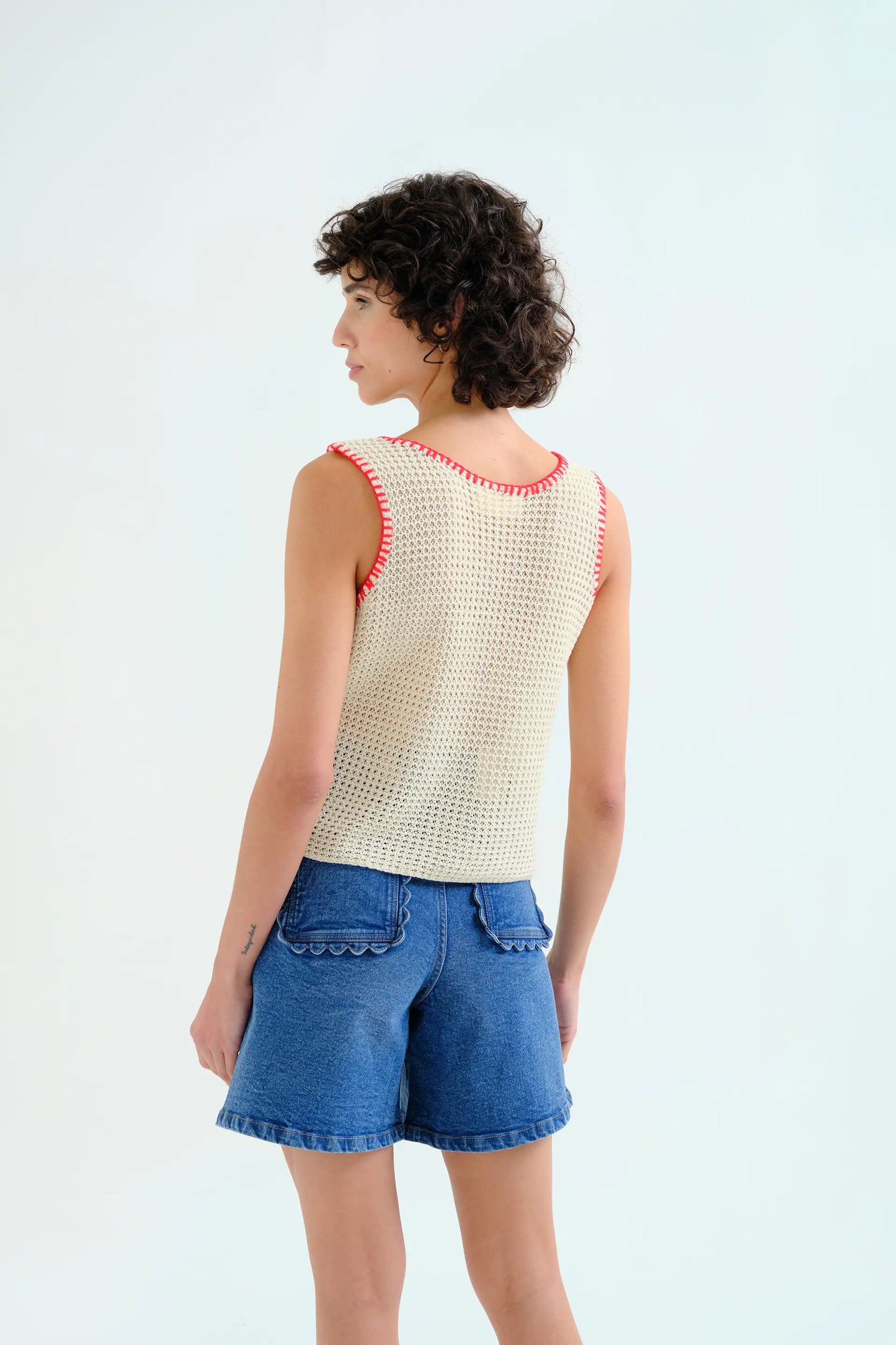 Off-white openwork knit top with red embroidered details