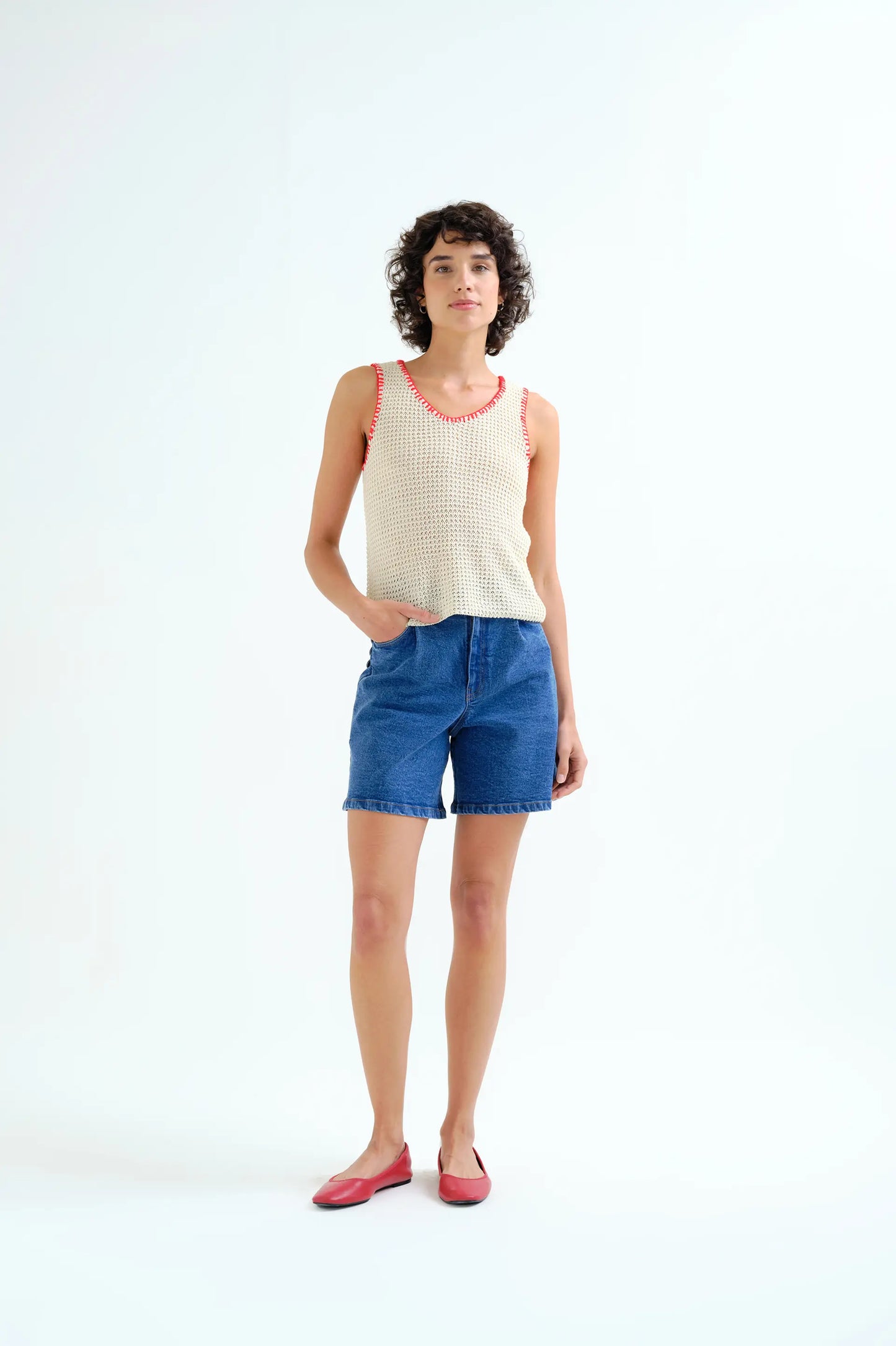 Off-white openwork knit top with red embroidered details