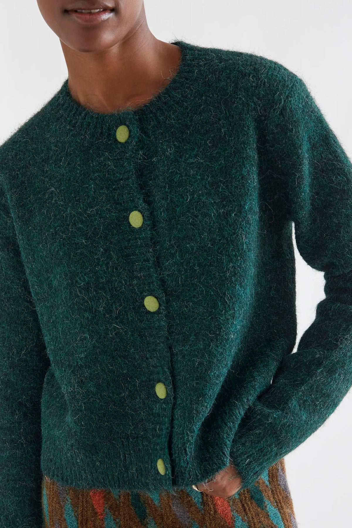 Dark green knit cardigan with light green buttons