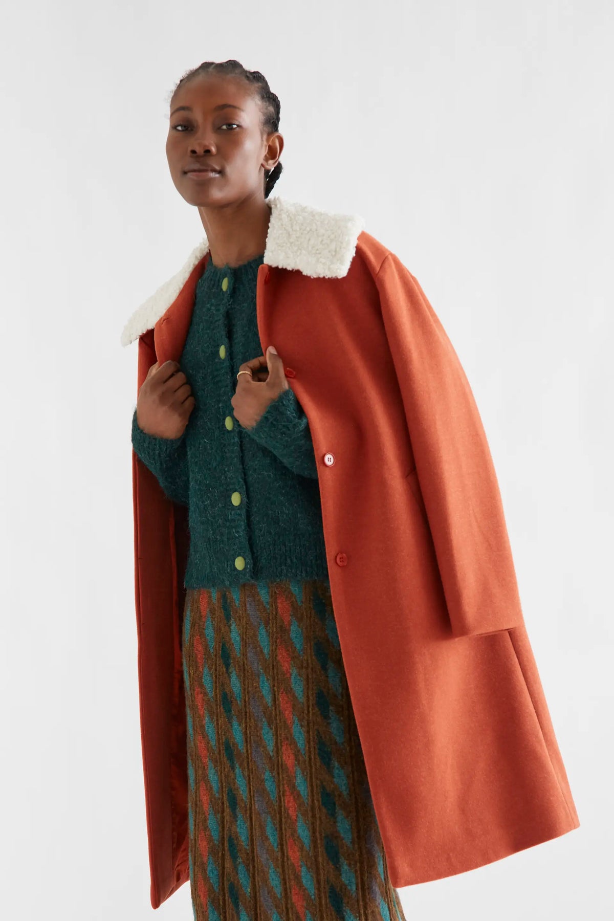 Dark green knit cardigan with light green buttons