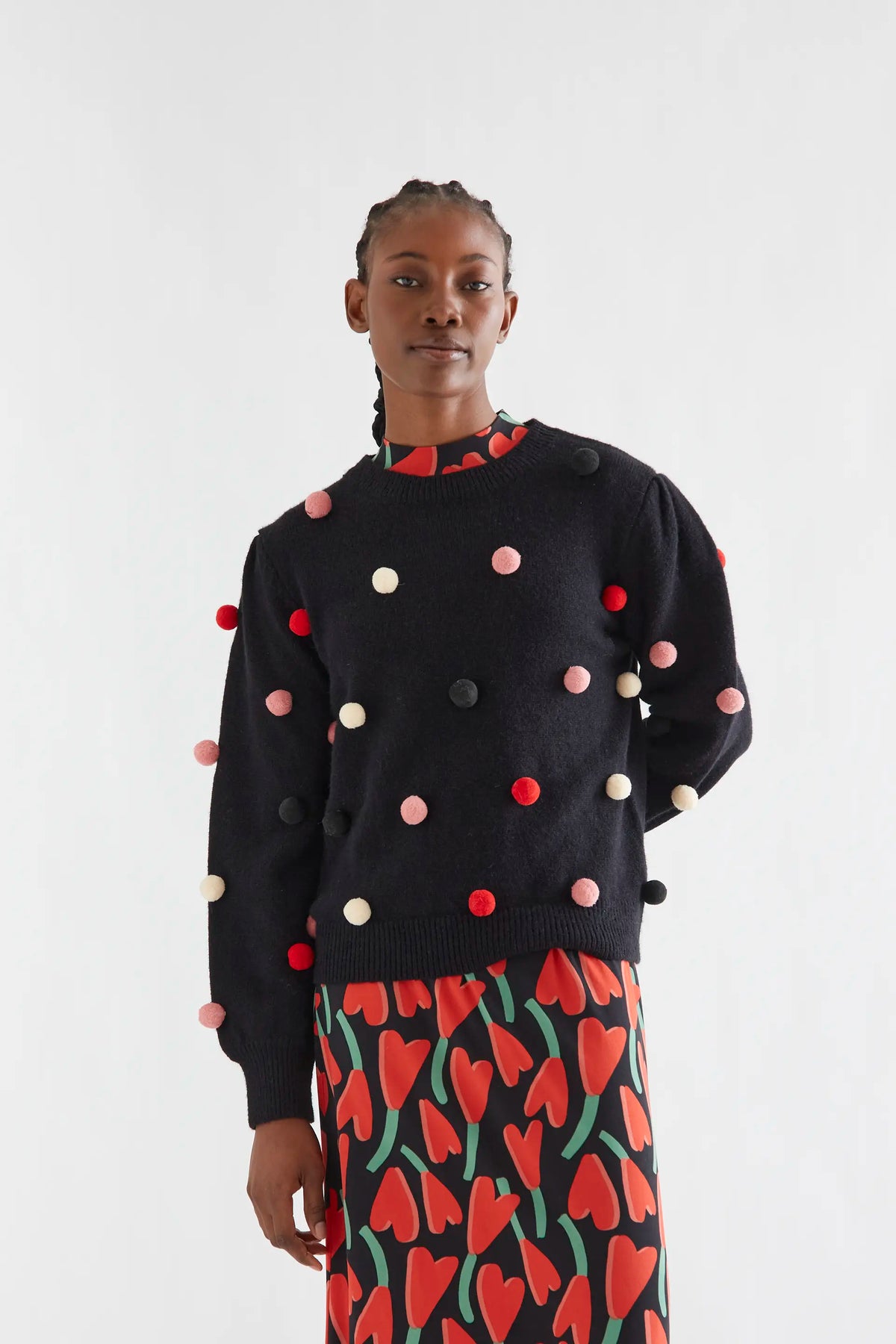 Black knit sweater with multicolored pompoms