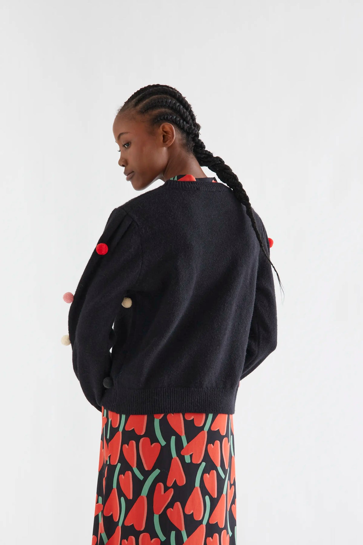 Black knit sweater with multicolored pompoms