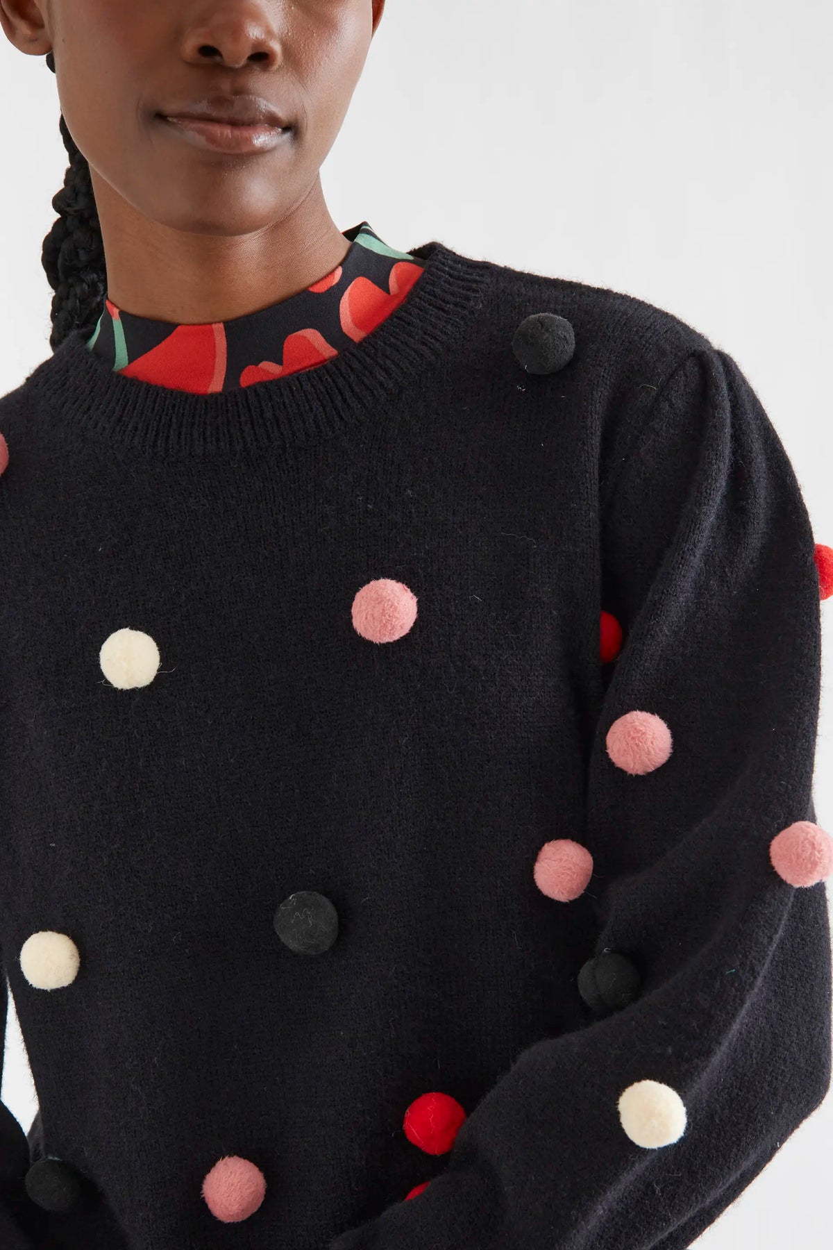 Black knit sweater with multicolored pompoms