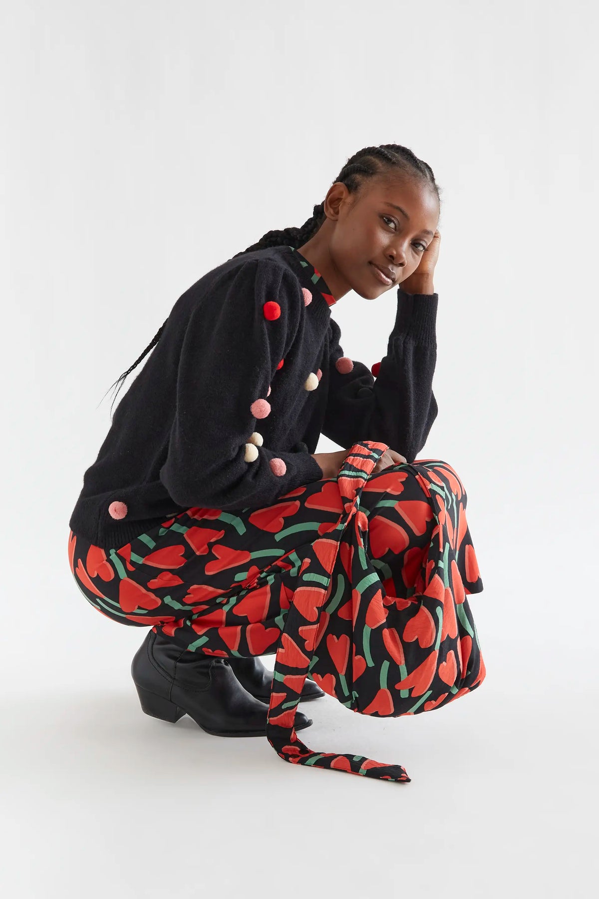 Black knit sweater with multicolored pompoms