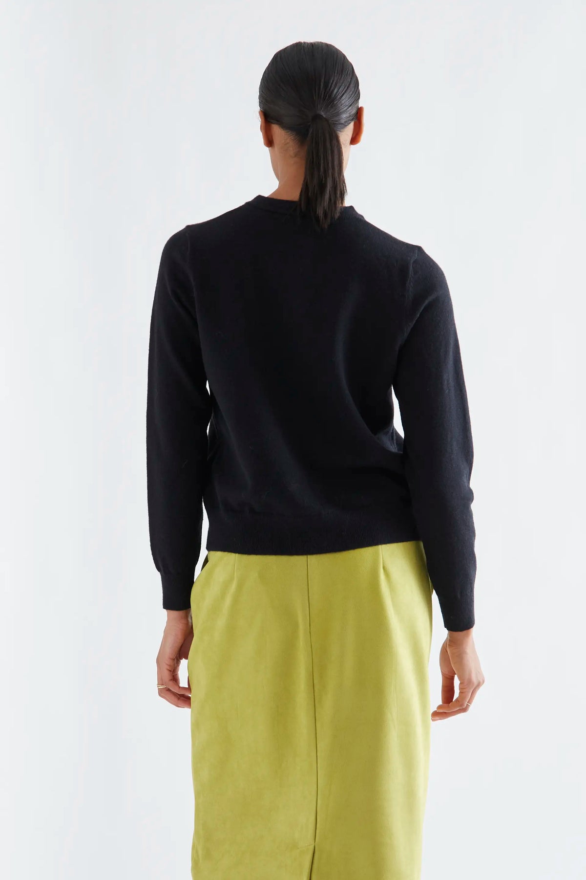 Black cardigan with white pompoms