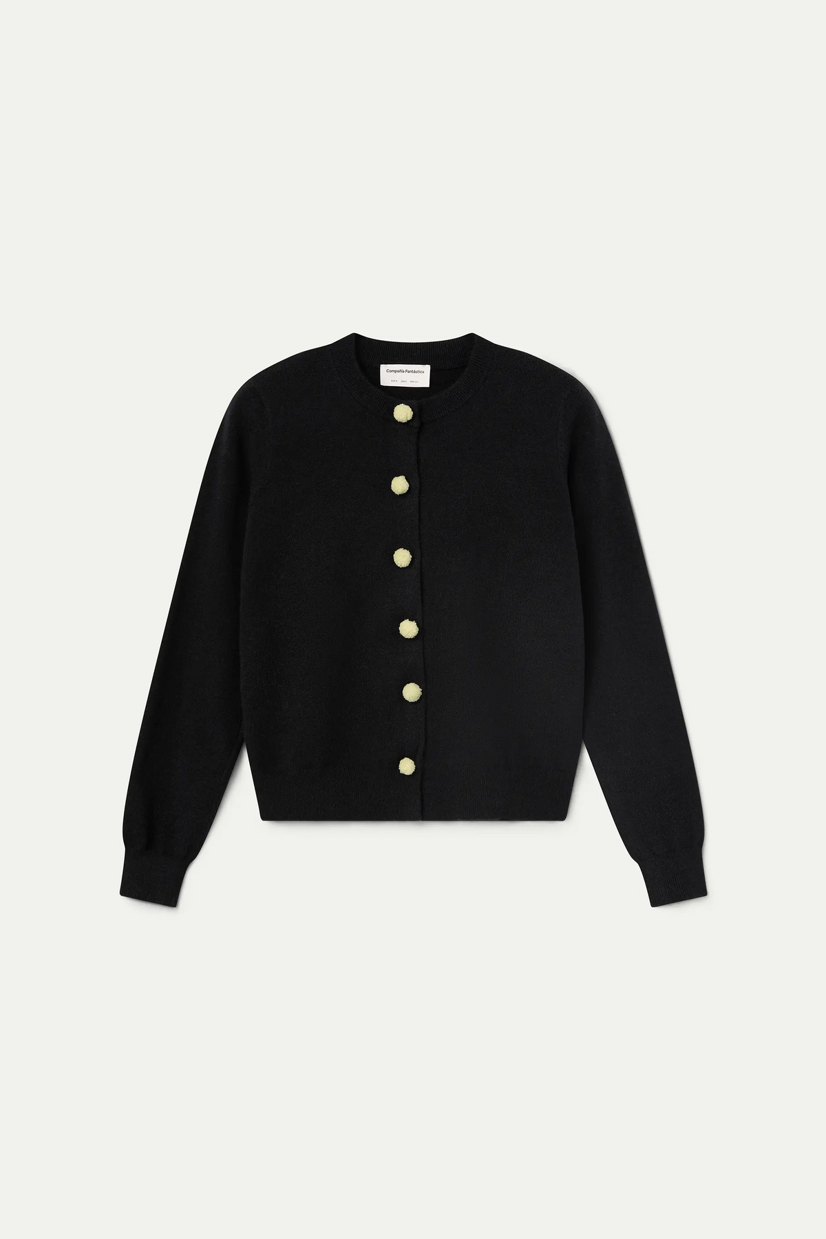 Black cardigan with white pompoms