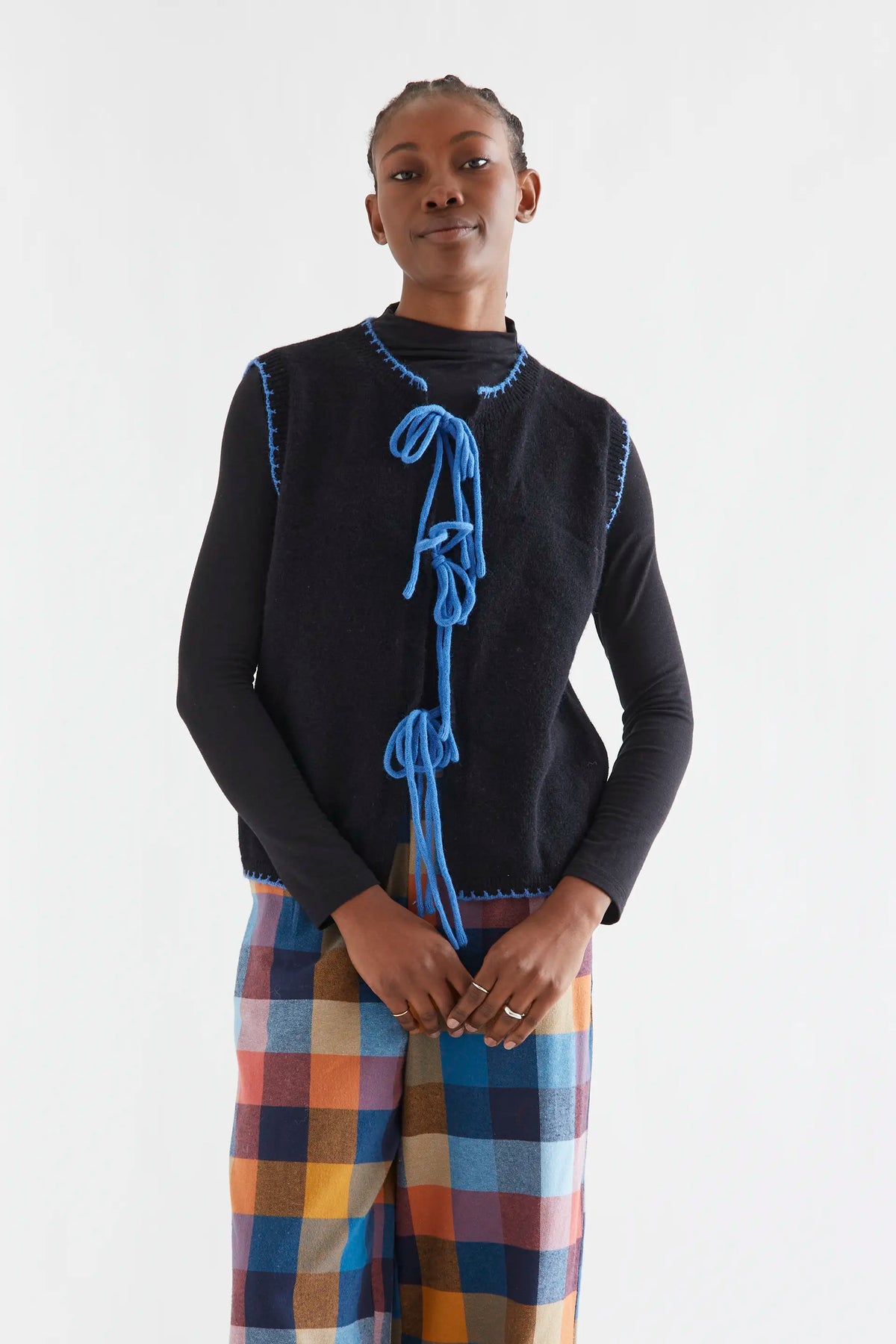 Black knit vest with light blue lace-up detail