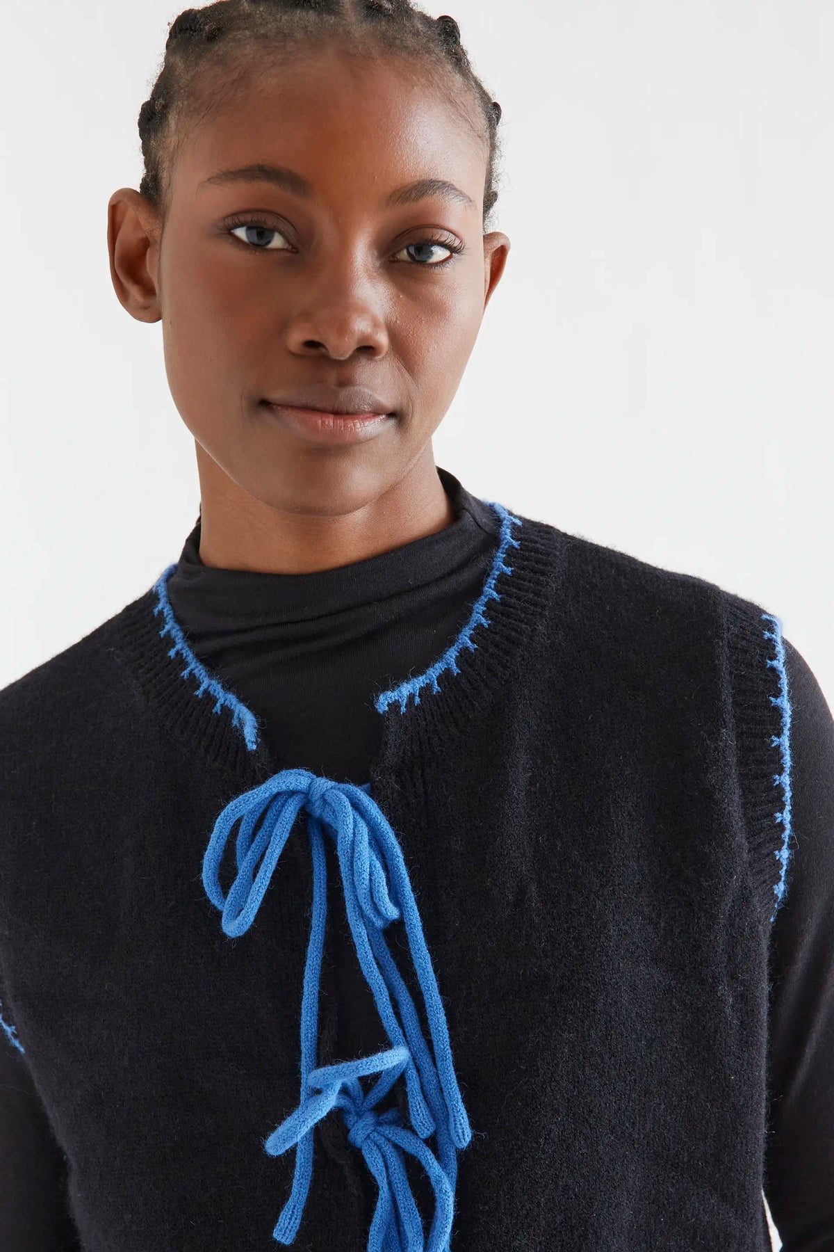 Black knit vest with light blue lace-up detail