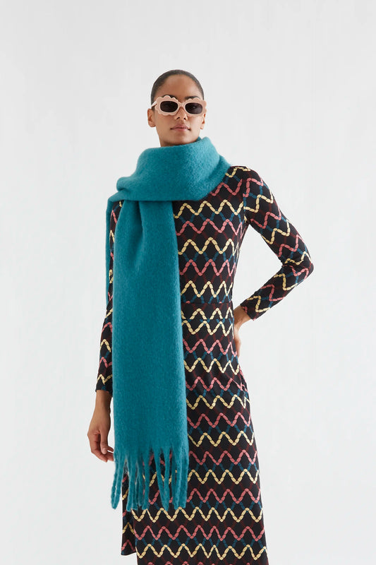 Dark green knitted scarf with fringe