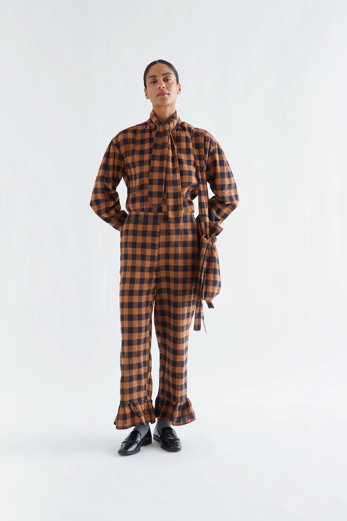 100% cotton pants with a brown and navy plaid pattern