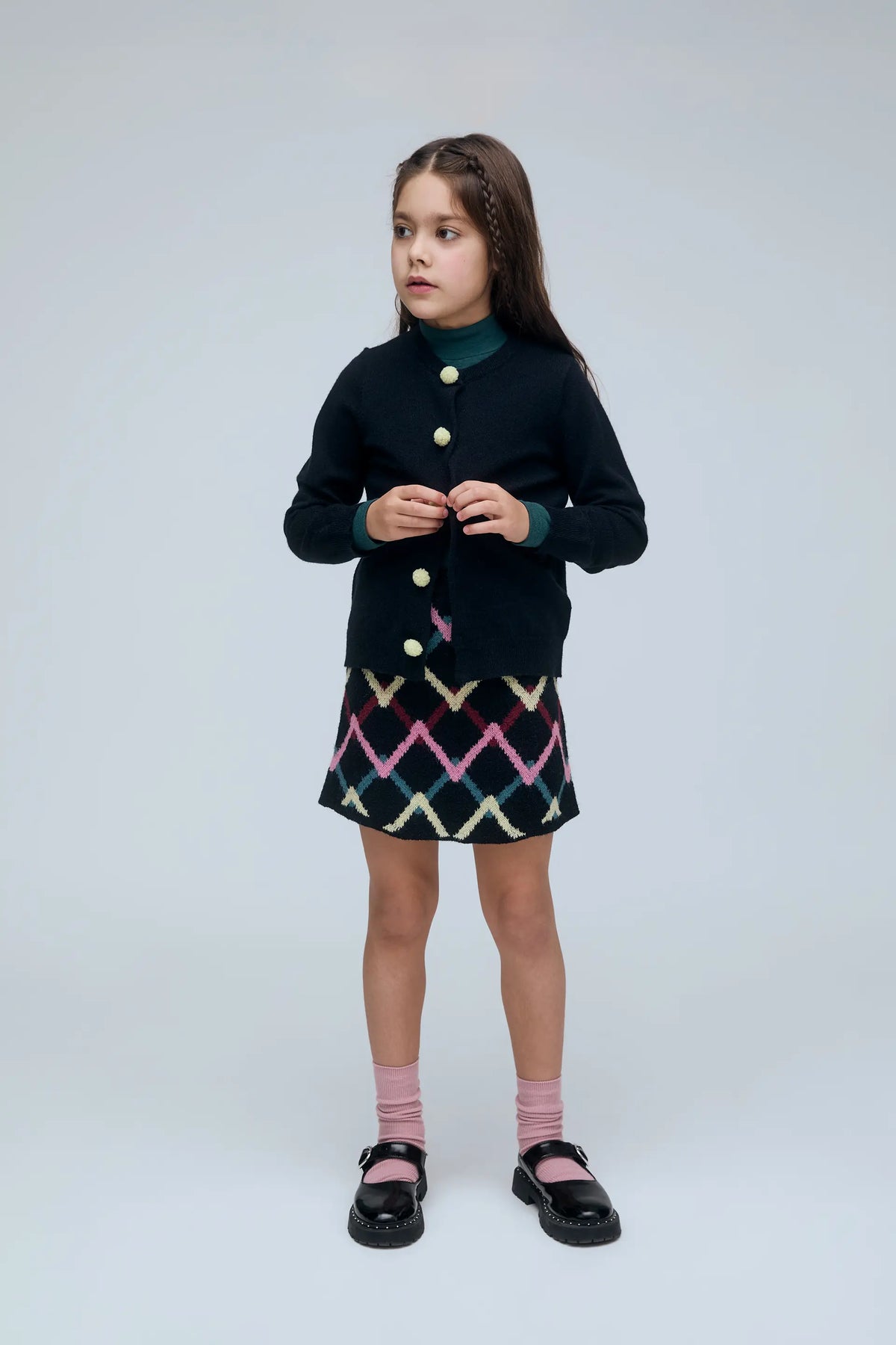 Cardigan nero da bambina con bottoni a pompon