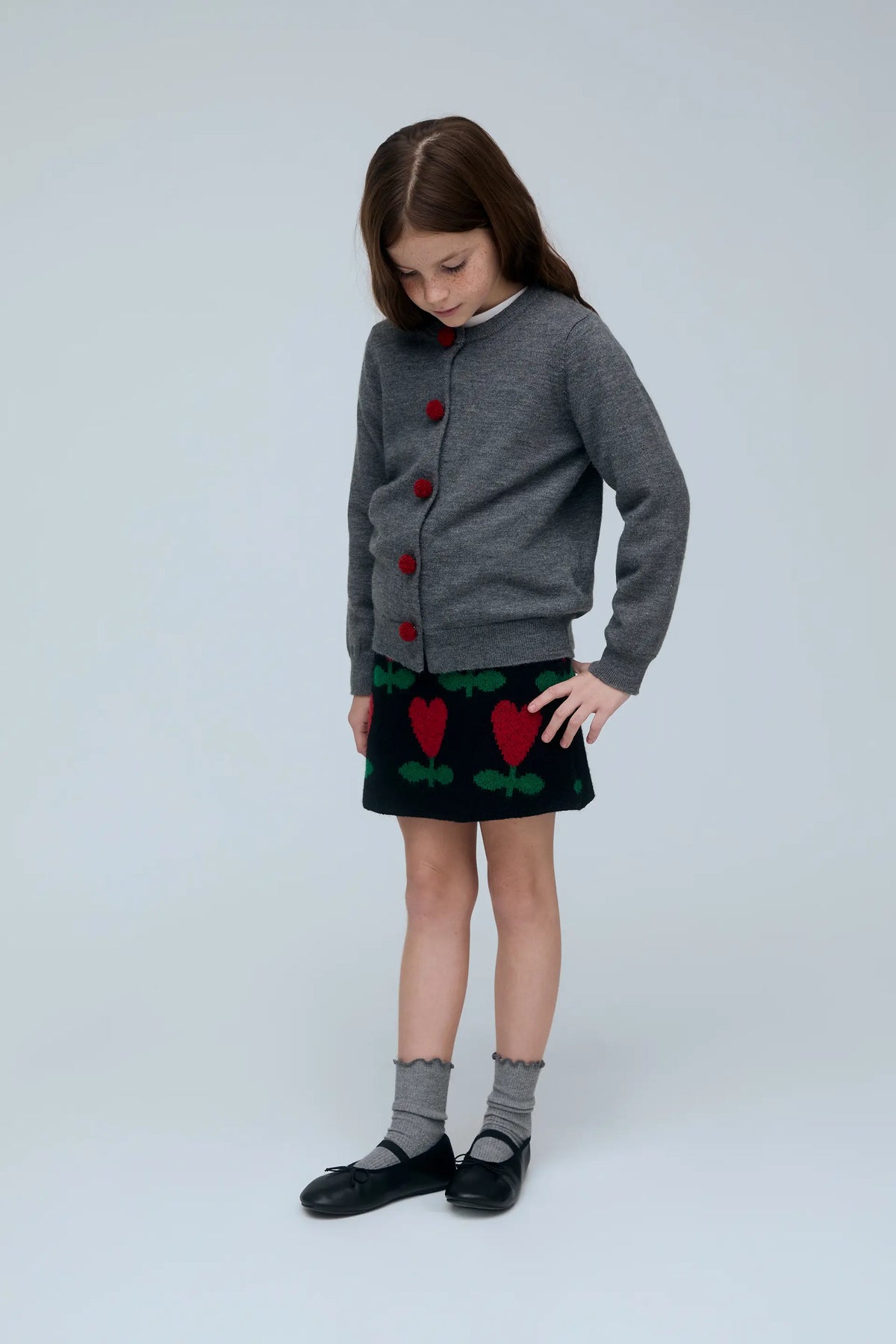 Cárdigan negro de niña gris con botones de pompones